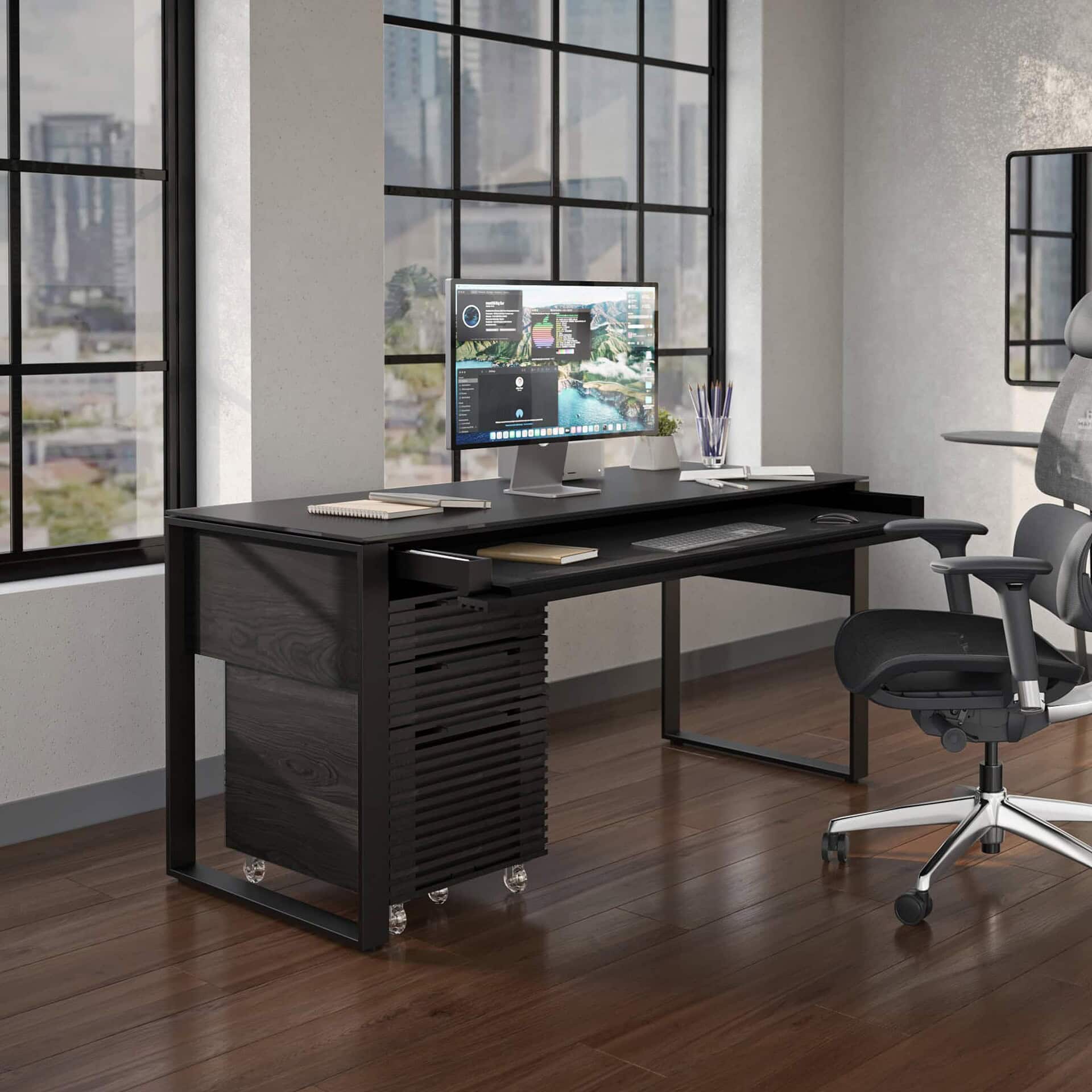 Sleek black modern office desk with computer setup in stylish workspace.