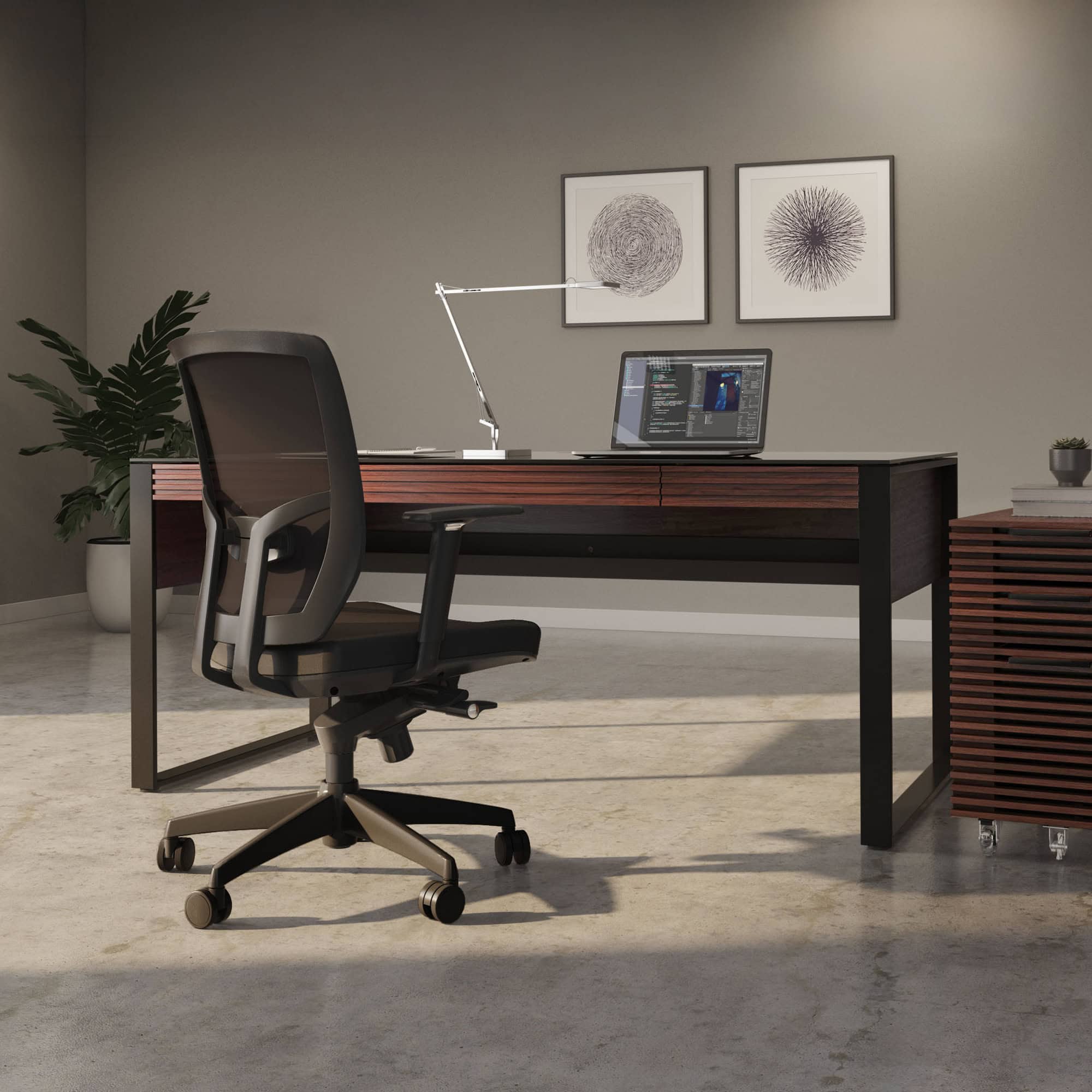 Elegant office desk with modern ergonomic chair, ideal for professional workspaces.