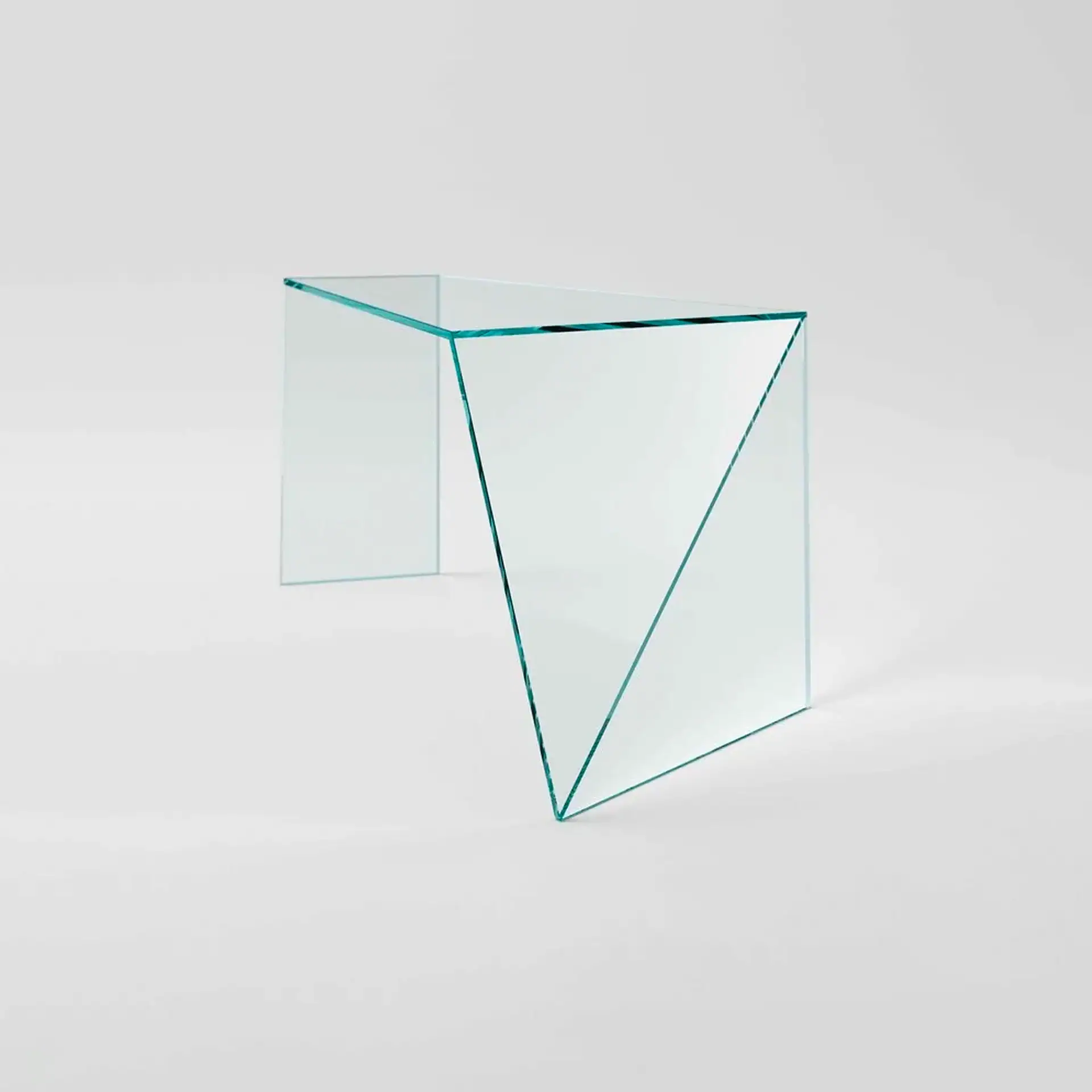 Sklar Furnishings glass desk with geometric design in a modern setting.