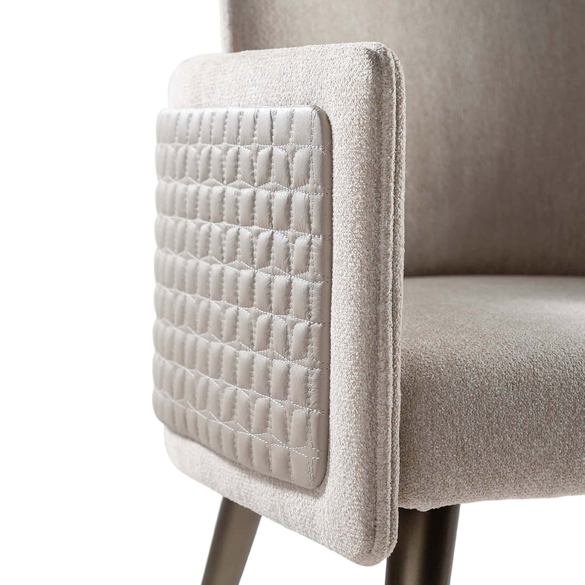 Luxurious beige upholstered accent chair with quilted side detail for modern home decor.