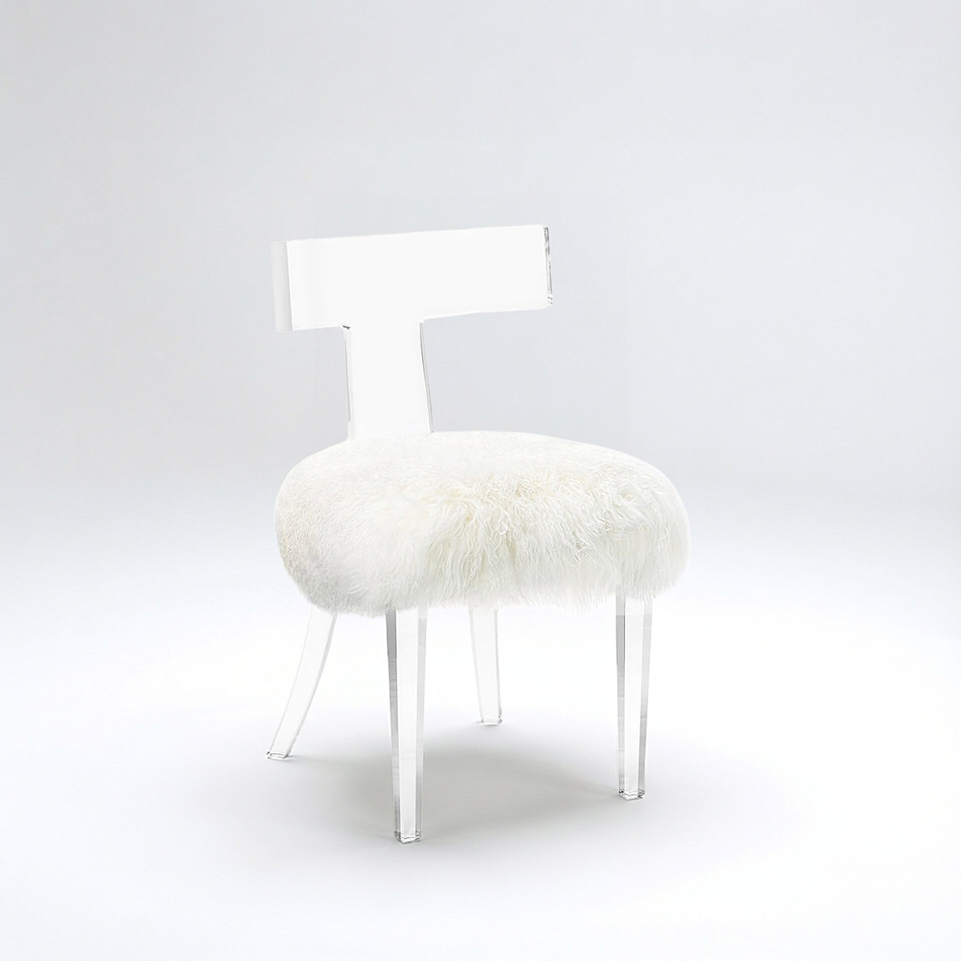 Tristan Acrylic Klismos Chair with clear acrylic frame and plush ivory sheepskin seat.