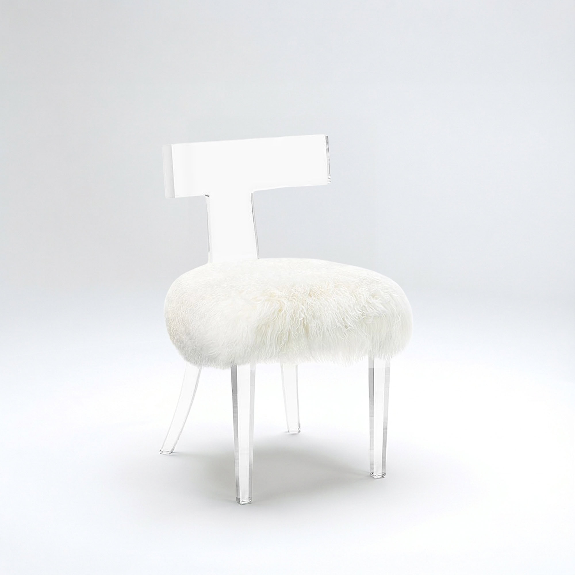 Tristan Acrylic Klismos Chair with clear acrylic frame and plush ivory sheepskin seat.