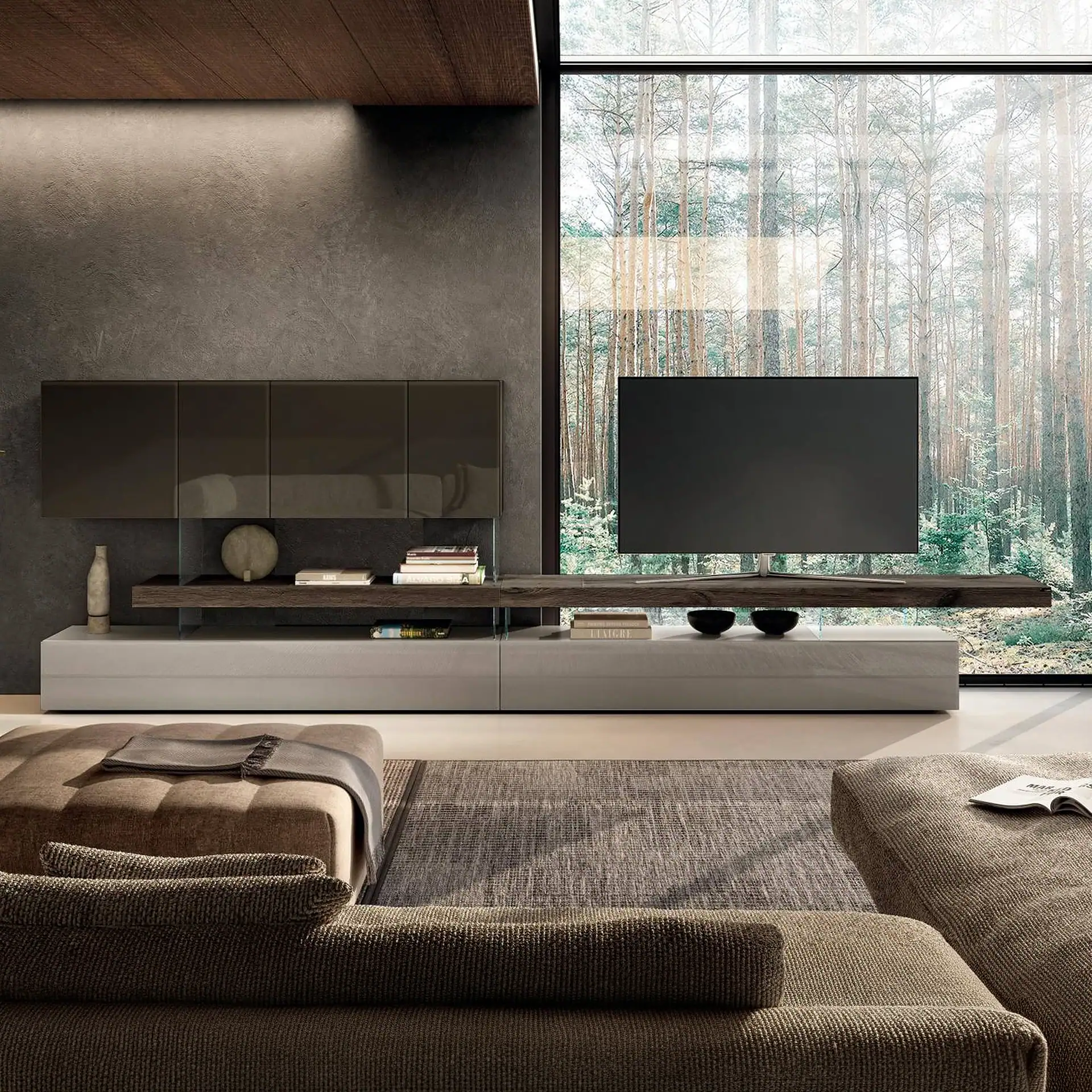 A modern living room with a large window overlooking a forest, featuring a dark gray wall, floating media console with a TV, and low-profile upholstered seating.