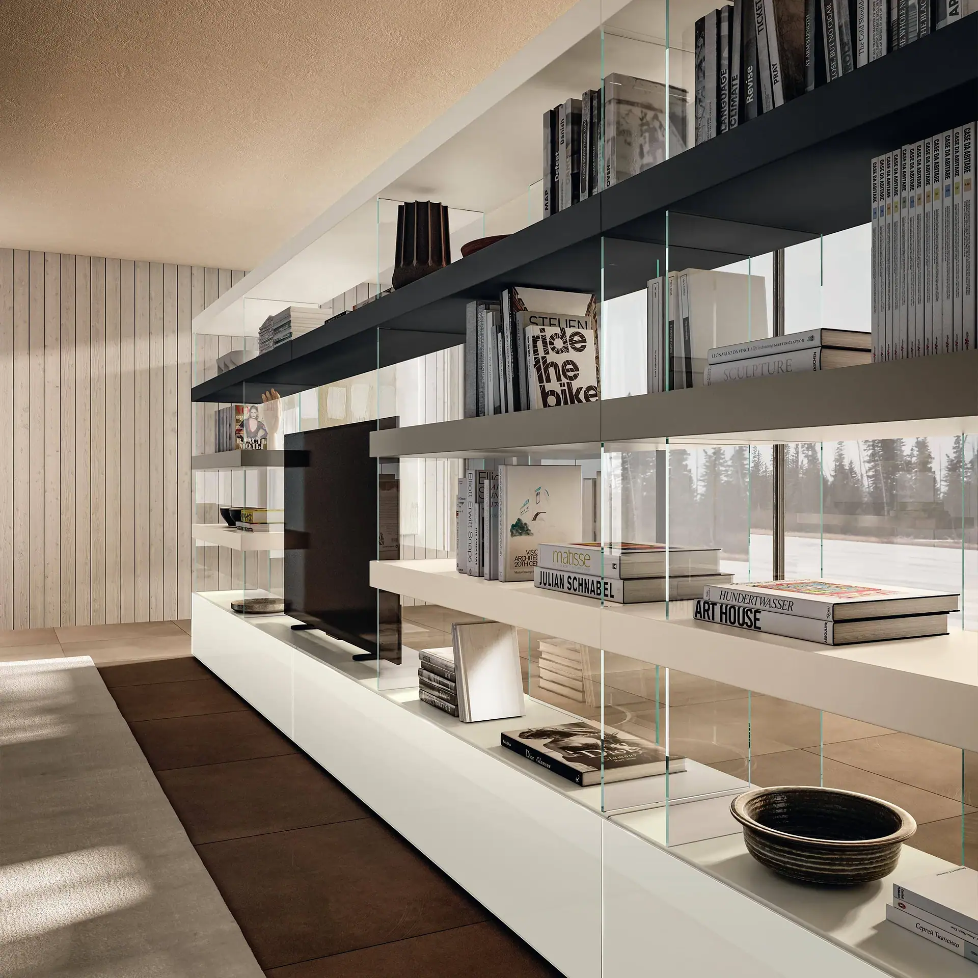 Modern living room featuring a large, minimalist shelving unit with white and dark gray shelves, glass dividers, an integrated TV, numerous books, and decorative items. A large window behind offers a view of a snowy landscape with trees.