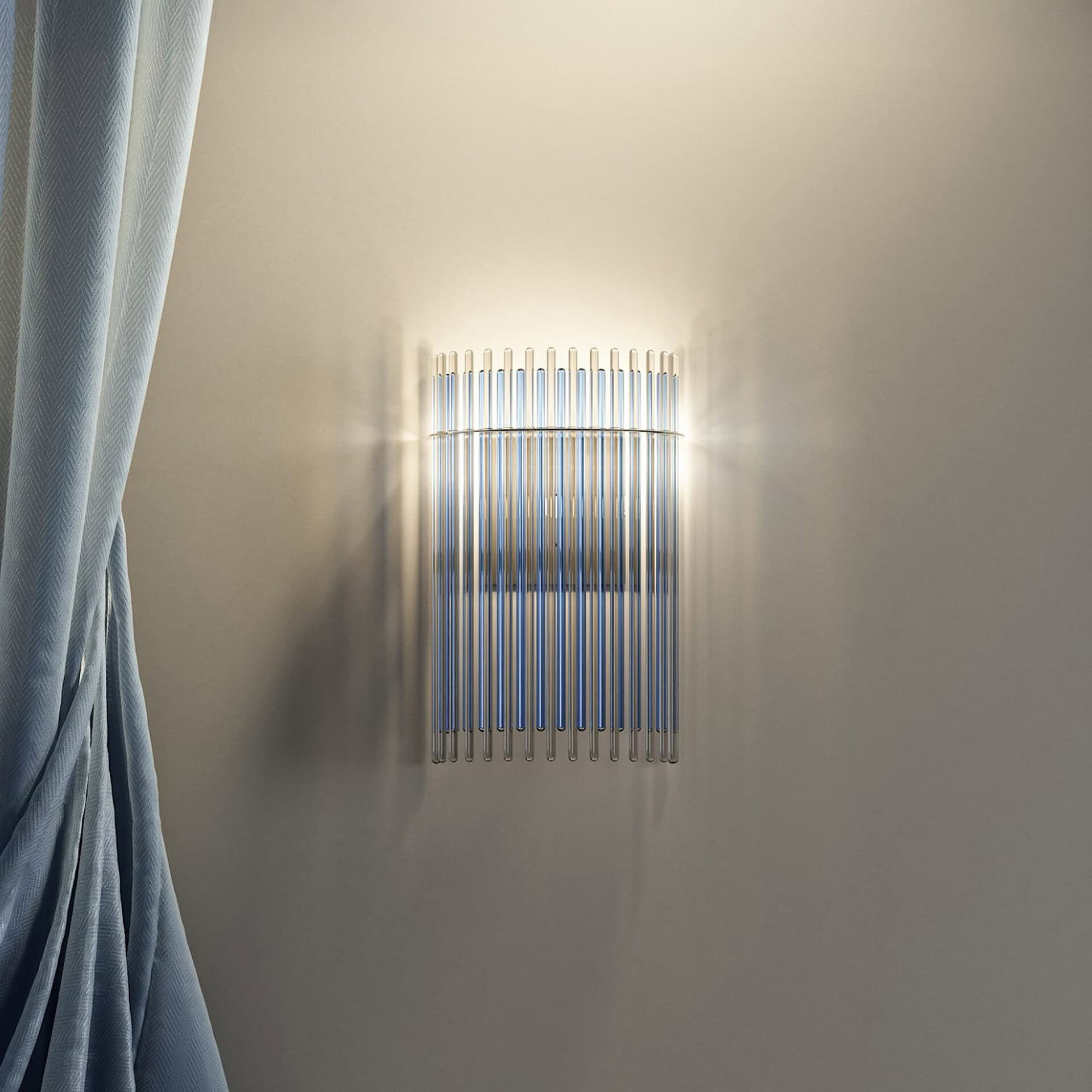 Charleston Wall Sconce by Reflex Angelo in Murano glass and polished metal, illuminated on a neutral wall.