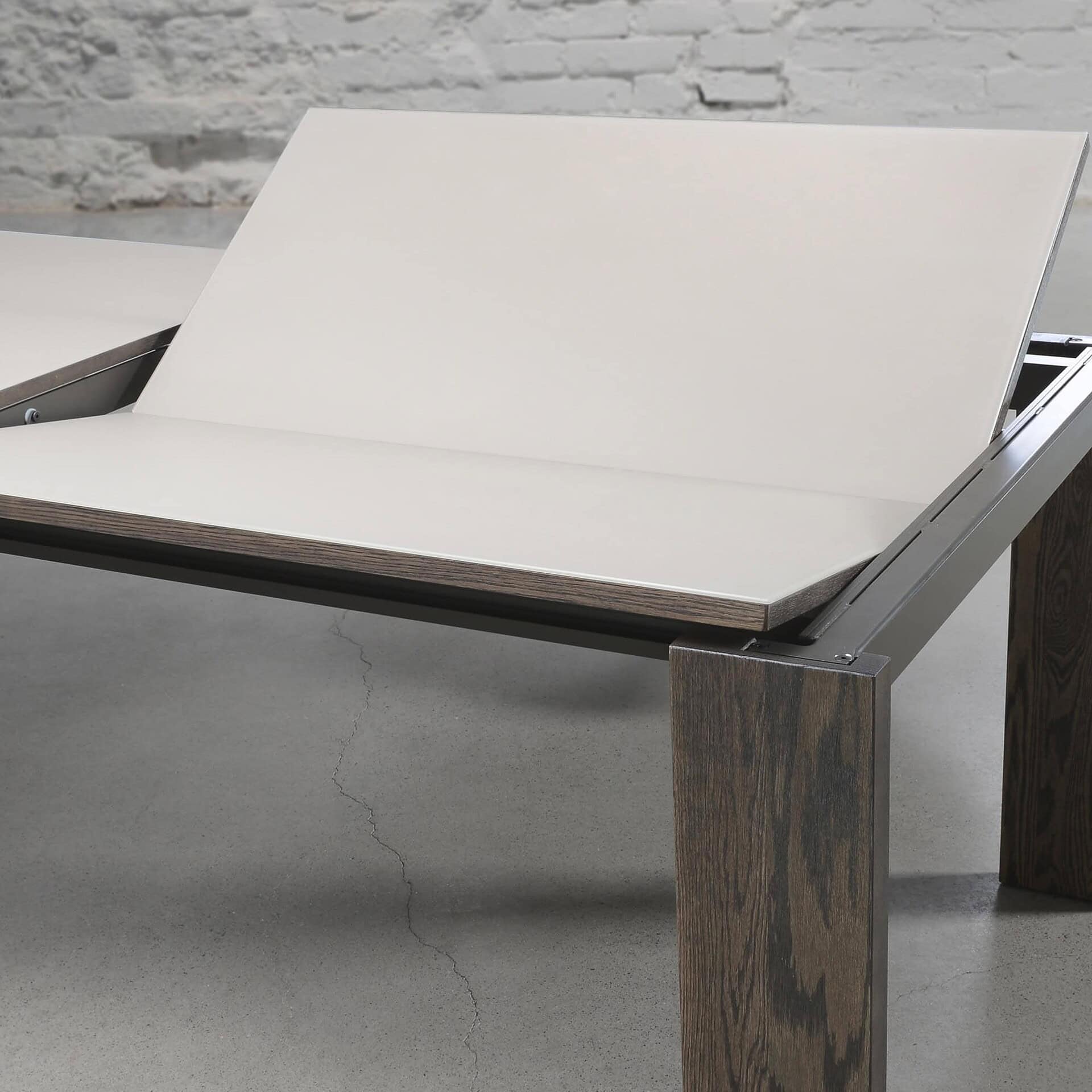 Close-up of Trica Empire Dining Table corner showing porcelain top and solid wood leg detail