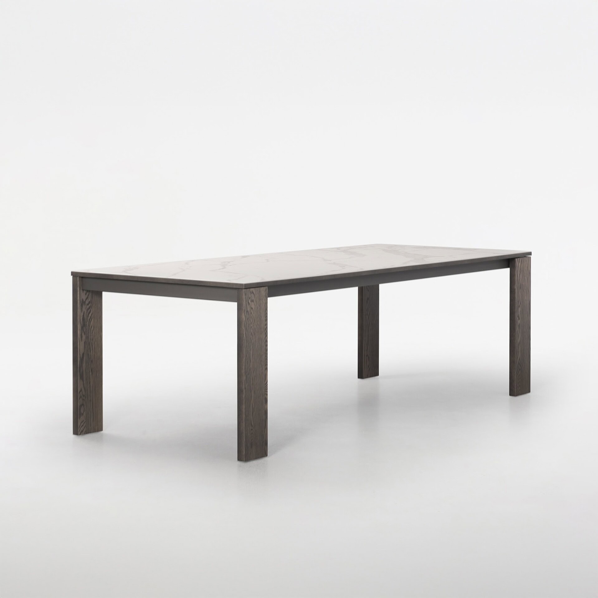 Trica Empire Extendable Dining Table, side angle view with wood base and porcelain top