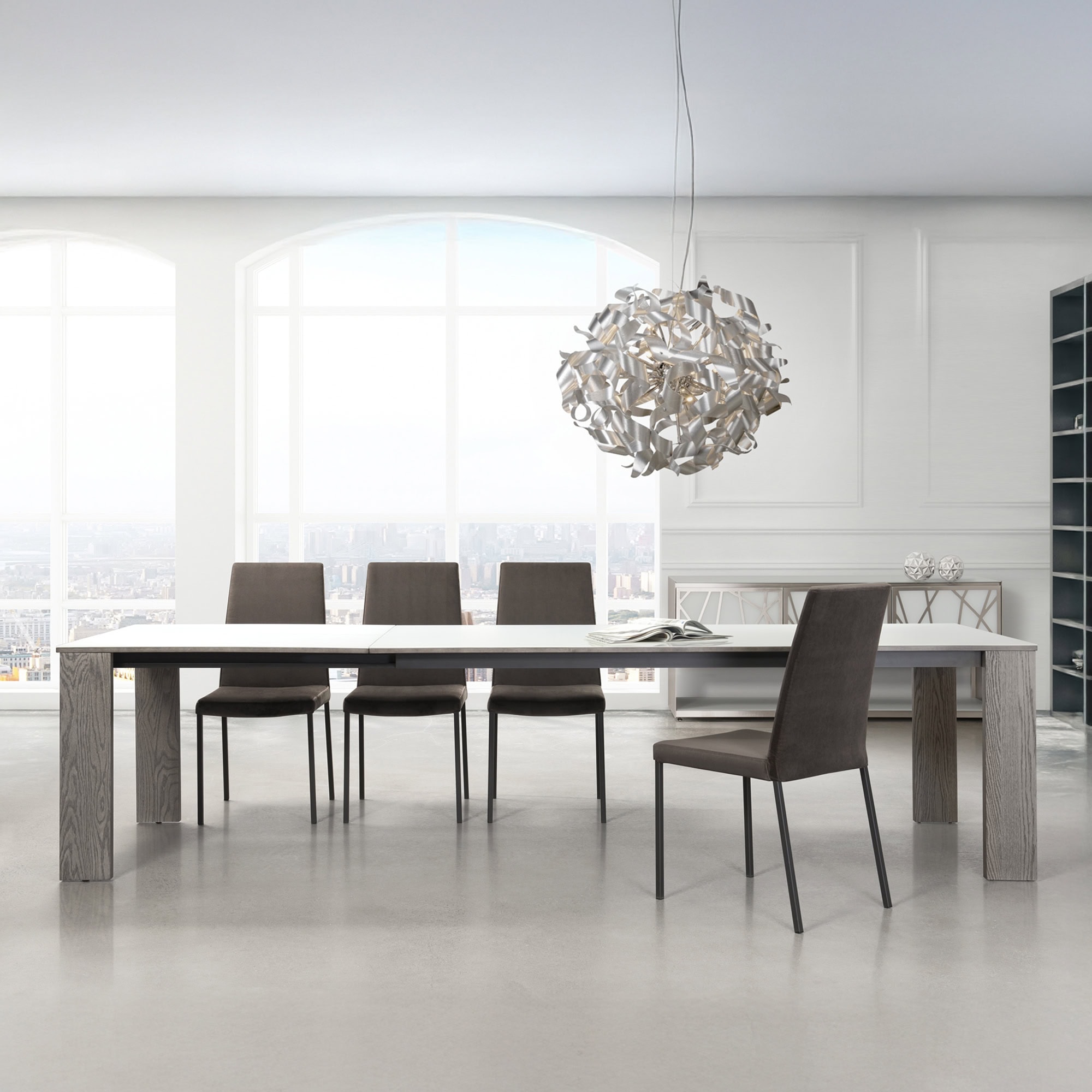 Trica Empire Extendable Dining Table in a modern dining room with chairs, shown in extended position