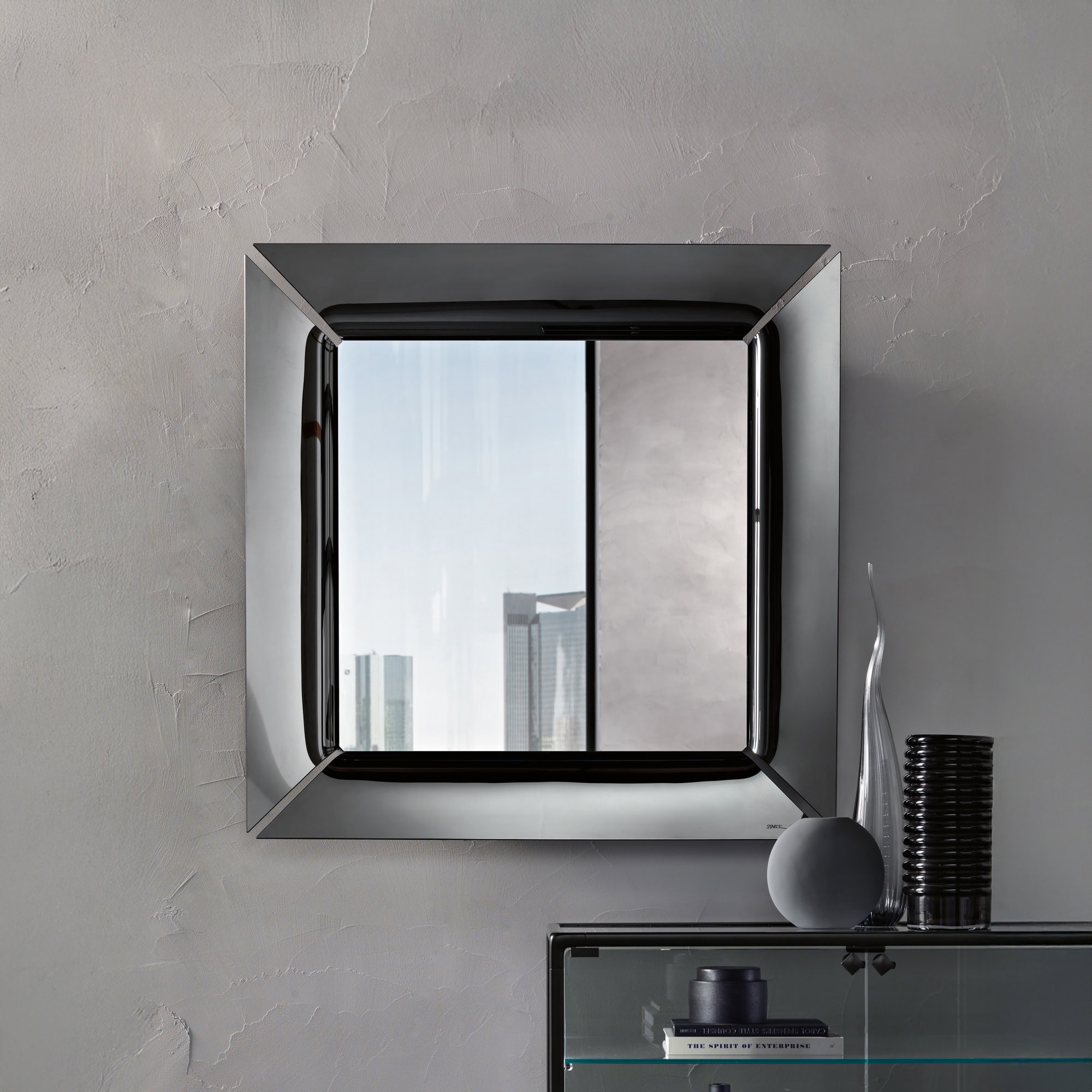 Square Caadre Mirror hung on a wall above a console, showcasing the bold glass frame.