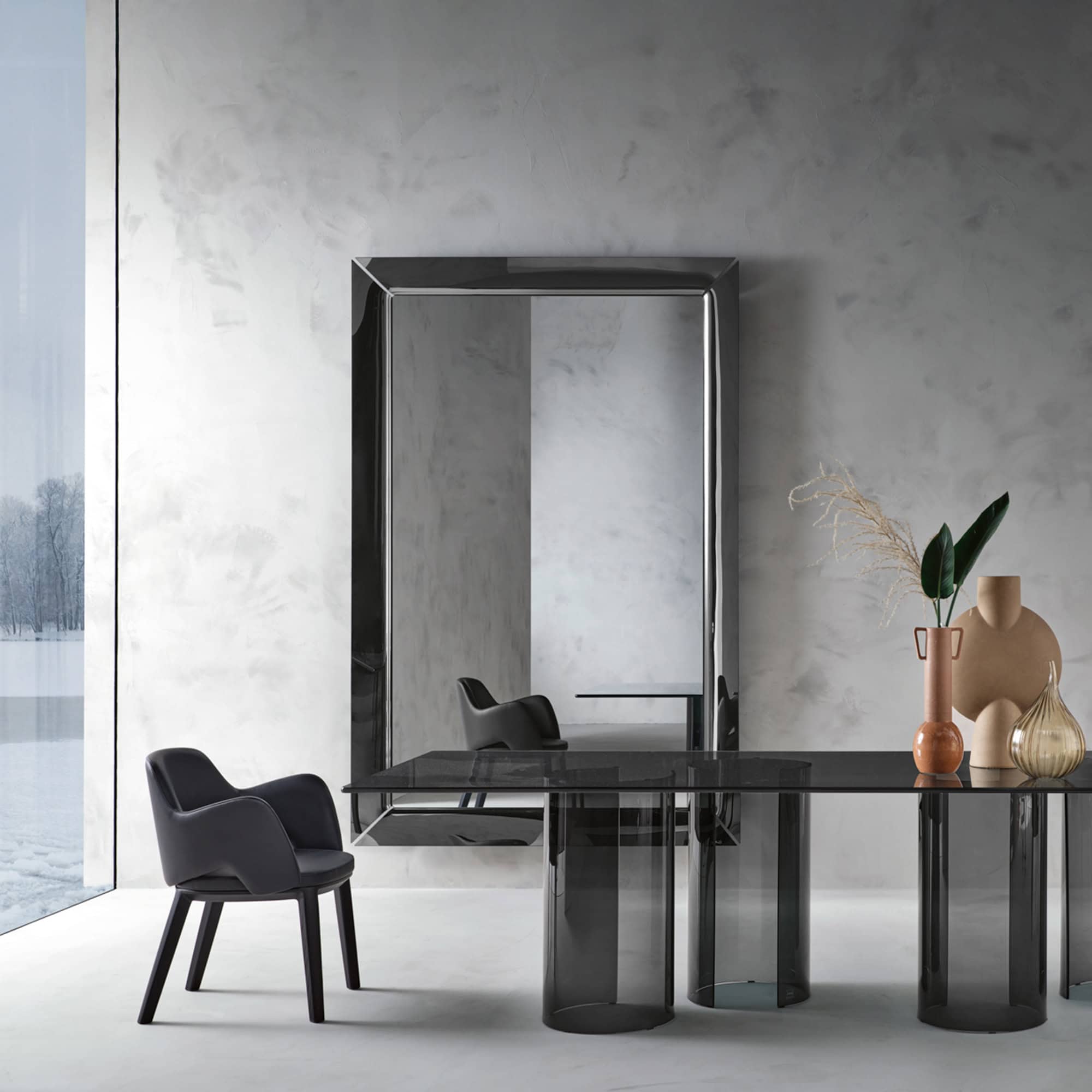 Large Caadre Mirror in a modern interior with dining table and chairs, emphasizing its full height and reflective presence.