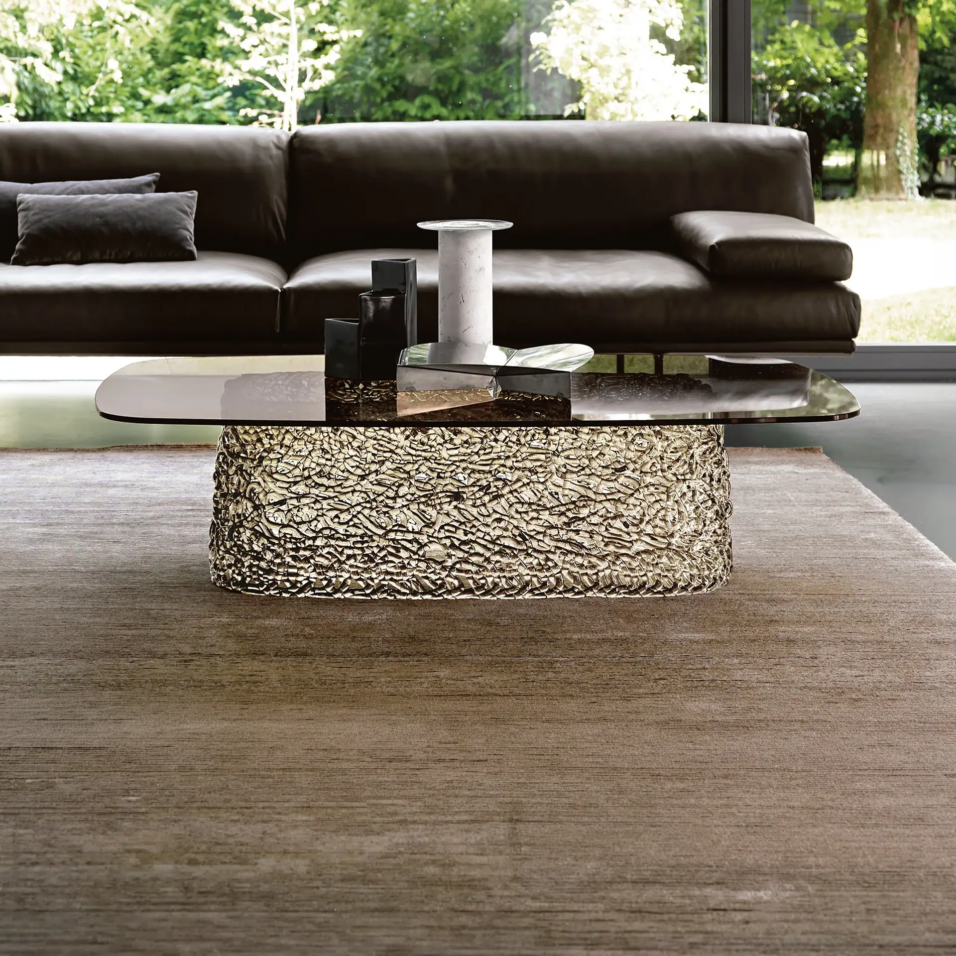 Macramè Coffee Table in bronze glass finish styled in a modern living room with sofa seating