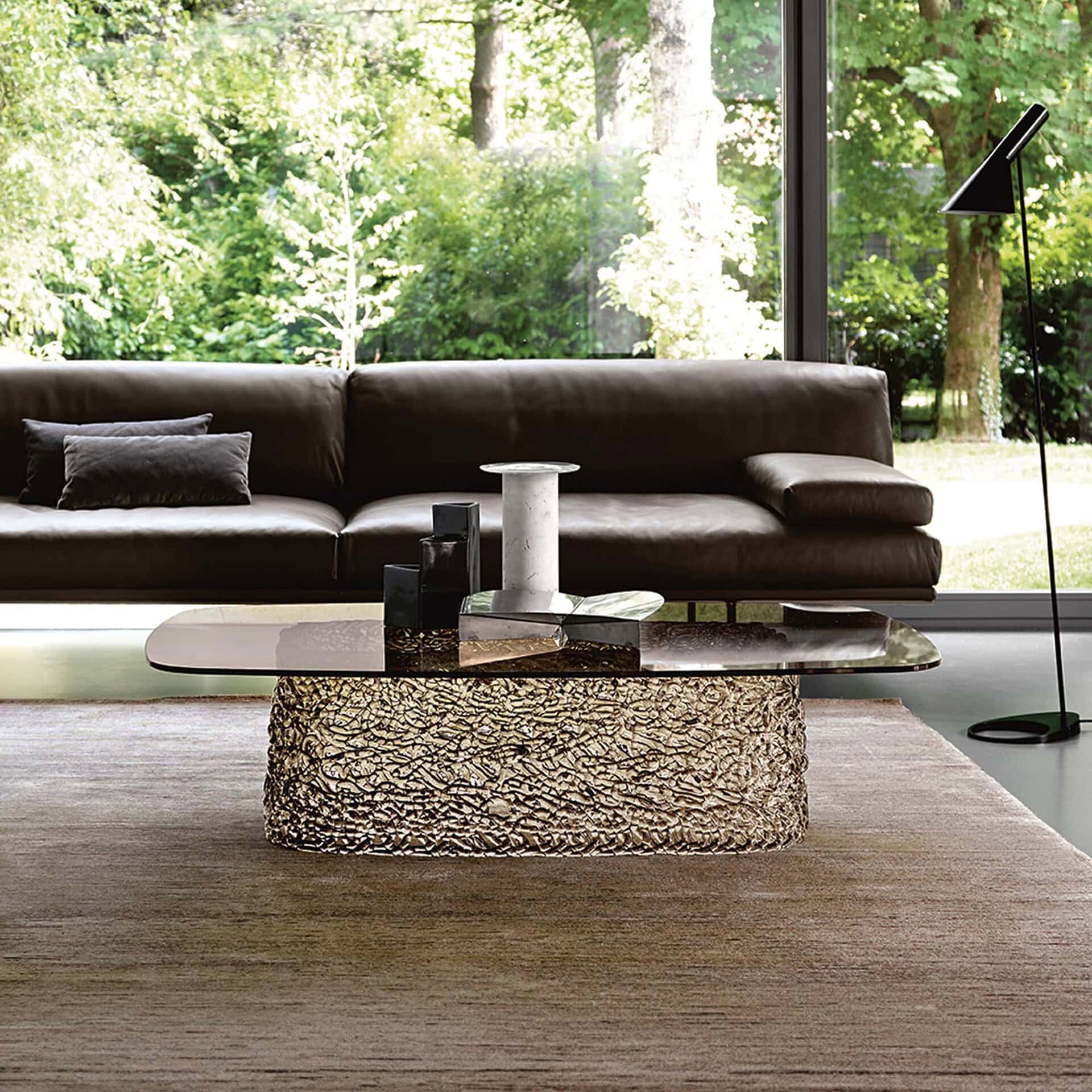 Macramè Coffee Table in bronze glass finish styled in a modern living room with sofa seating