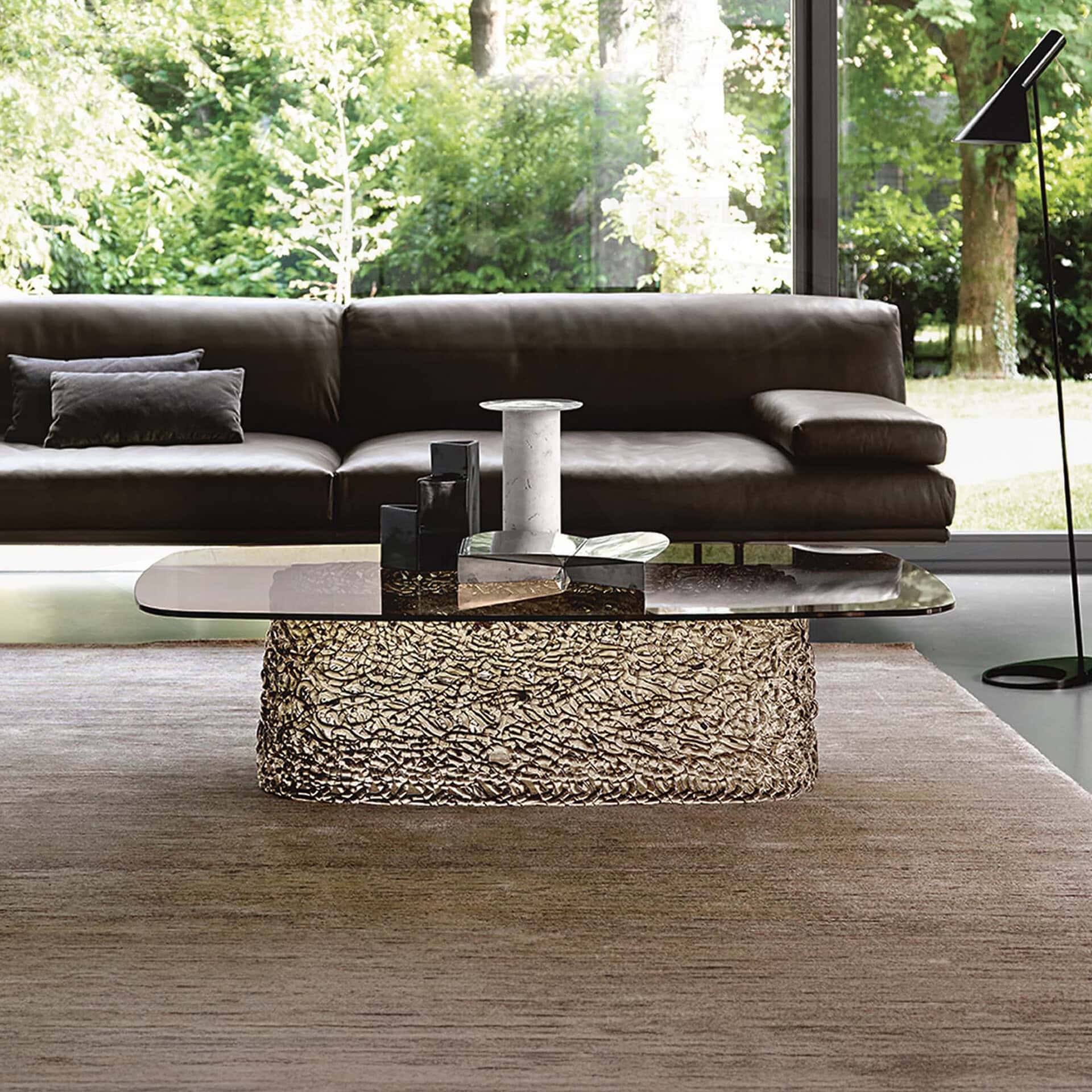Macramè Coffee Table in bronze glass finish styled in a modern living room with sofa seating