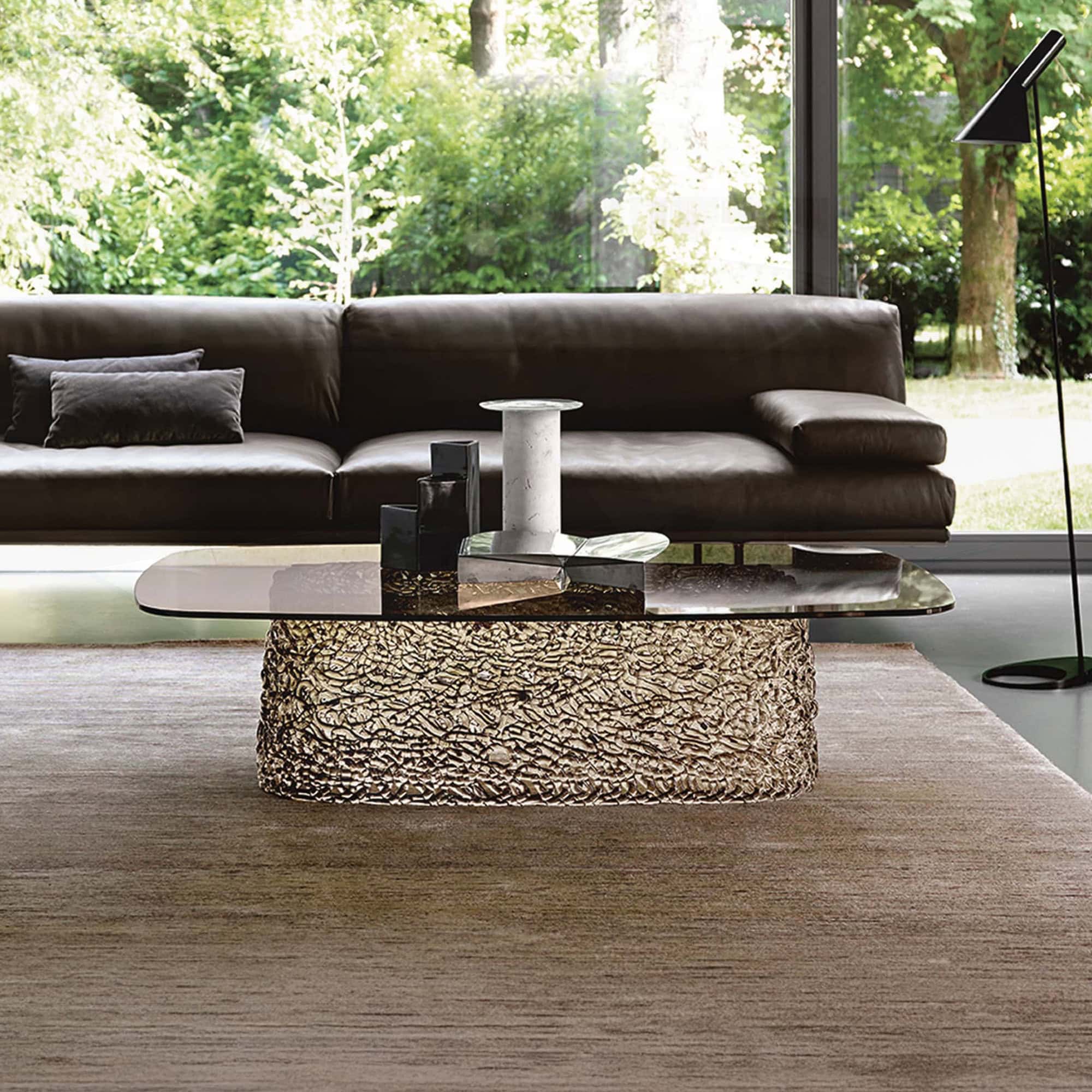 Macramè Coffee Table in bronze glass finish styled in a modern living room with sofa seating
