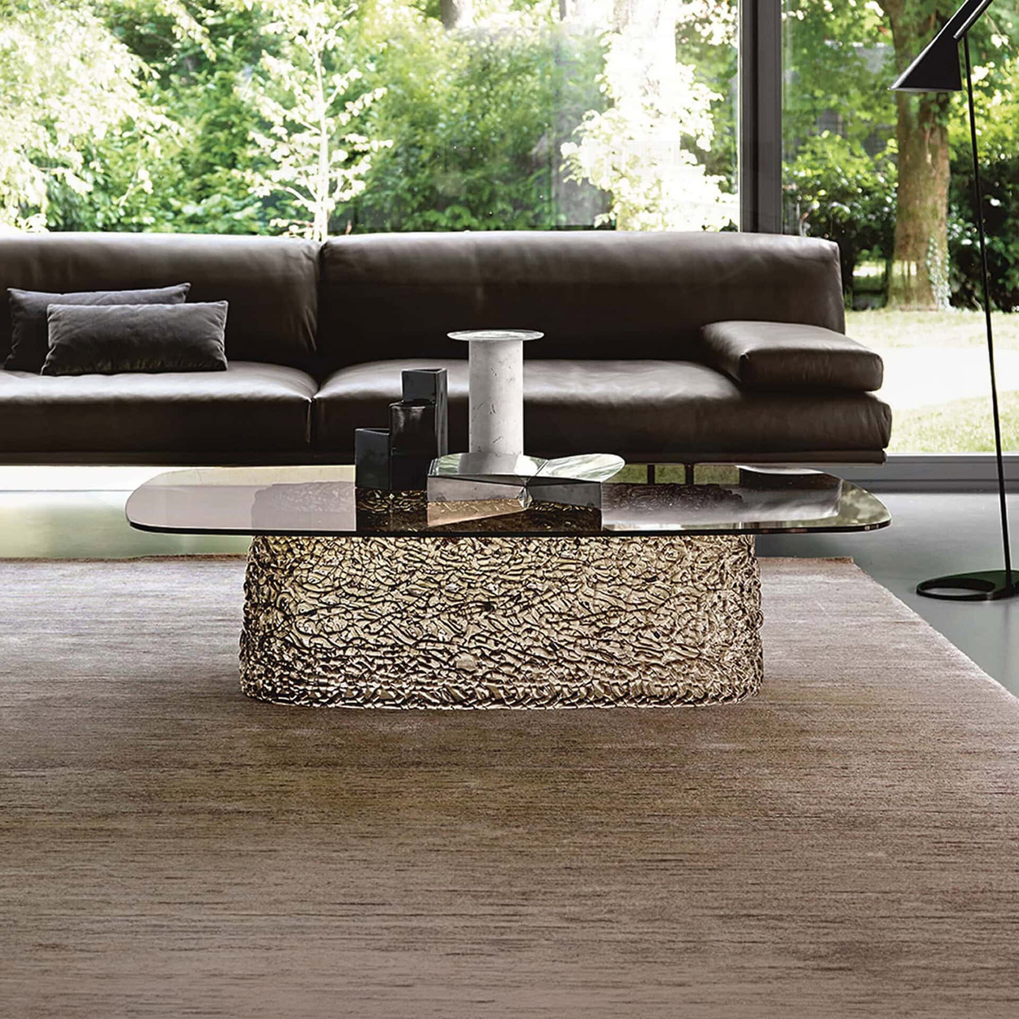 Macramè Coffee Table in bronze glass finish styled in a modern living room with sofa seating