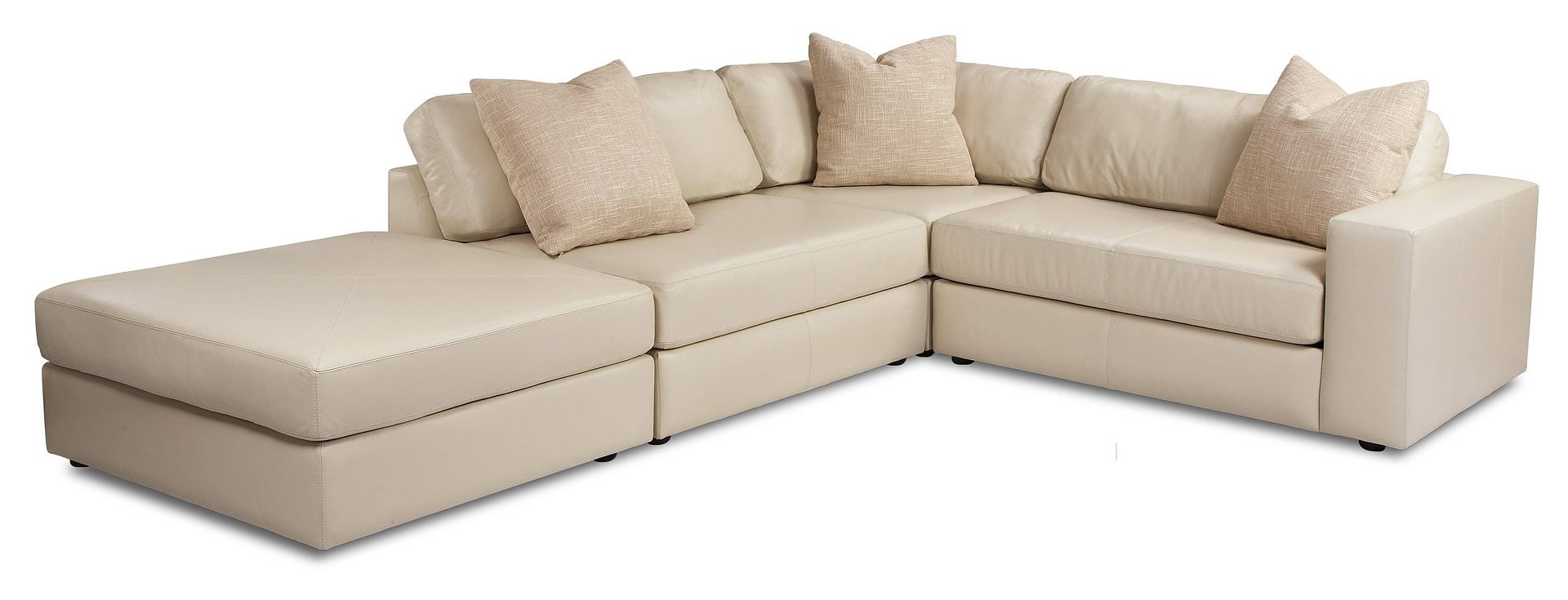 Luxurious beige sectional sofa with plush pillows, perfect for modern living rooms.