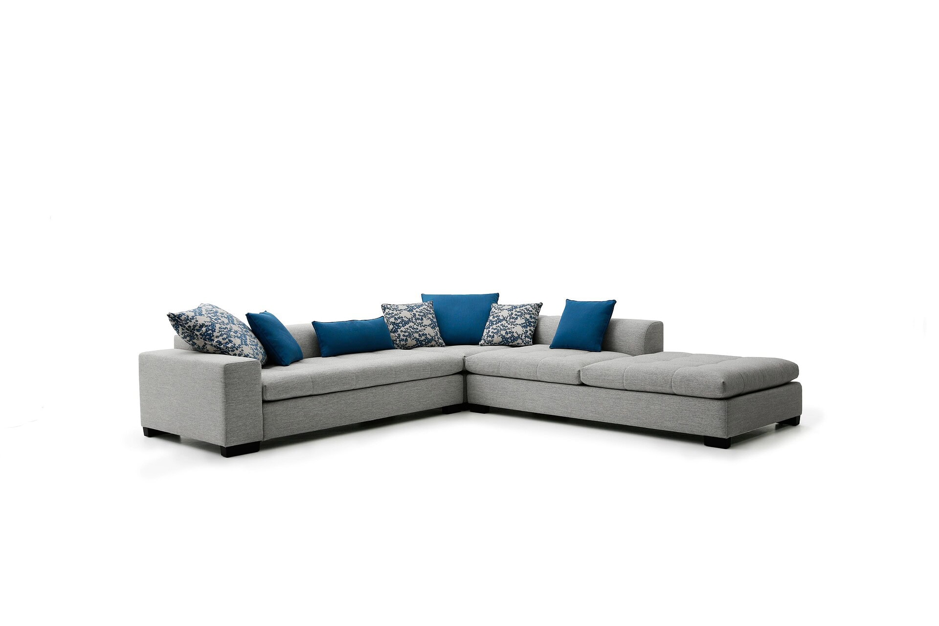 Comfy sectional sofa with blue throw pillows, perfect for modern living rooms.