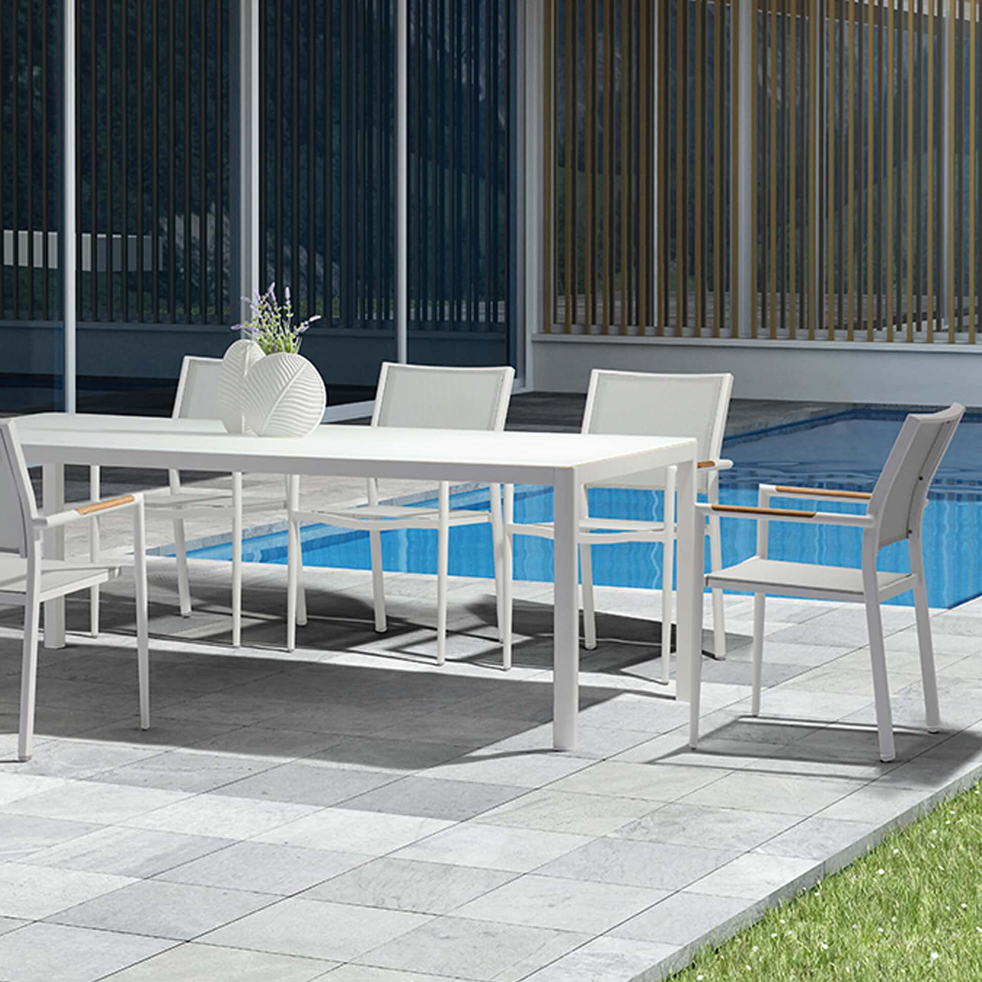 Outdoor dining furniture for poolside entertaining and relaxation.