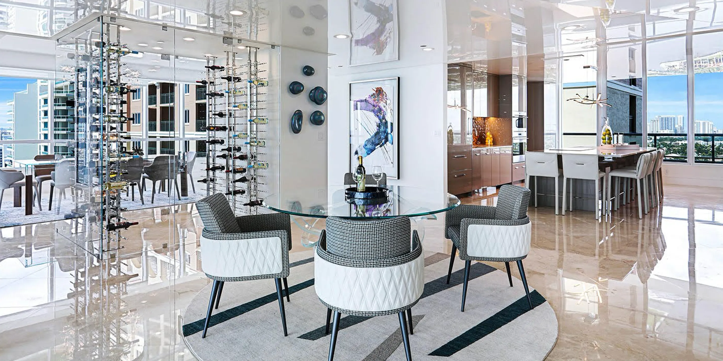A luxurious, modern apartment interior with a glass wine cellar, round dining table, sleek kitchen, and floor-to-ceiling windows overlooking a city skyline.