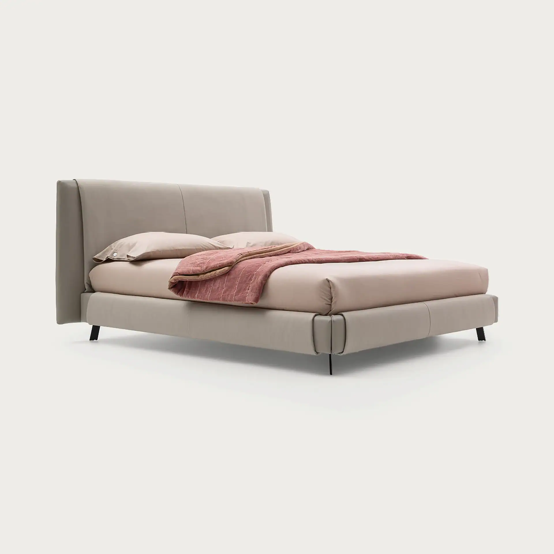 Kailua Bed with upholstered headboard and base on legs.
