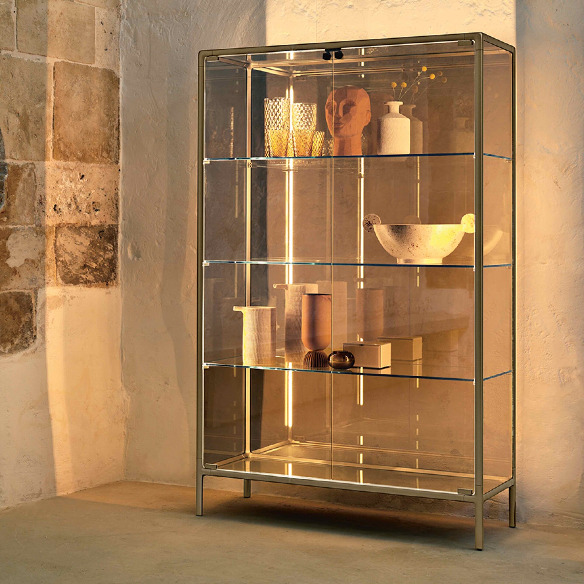 Sleek glass display cabinet by Sklar Furnishings showcasing modern home decor accents.