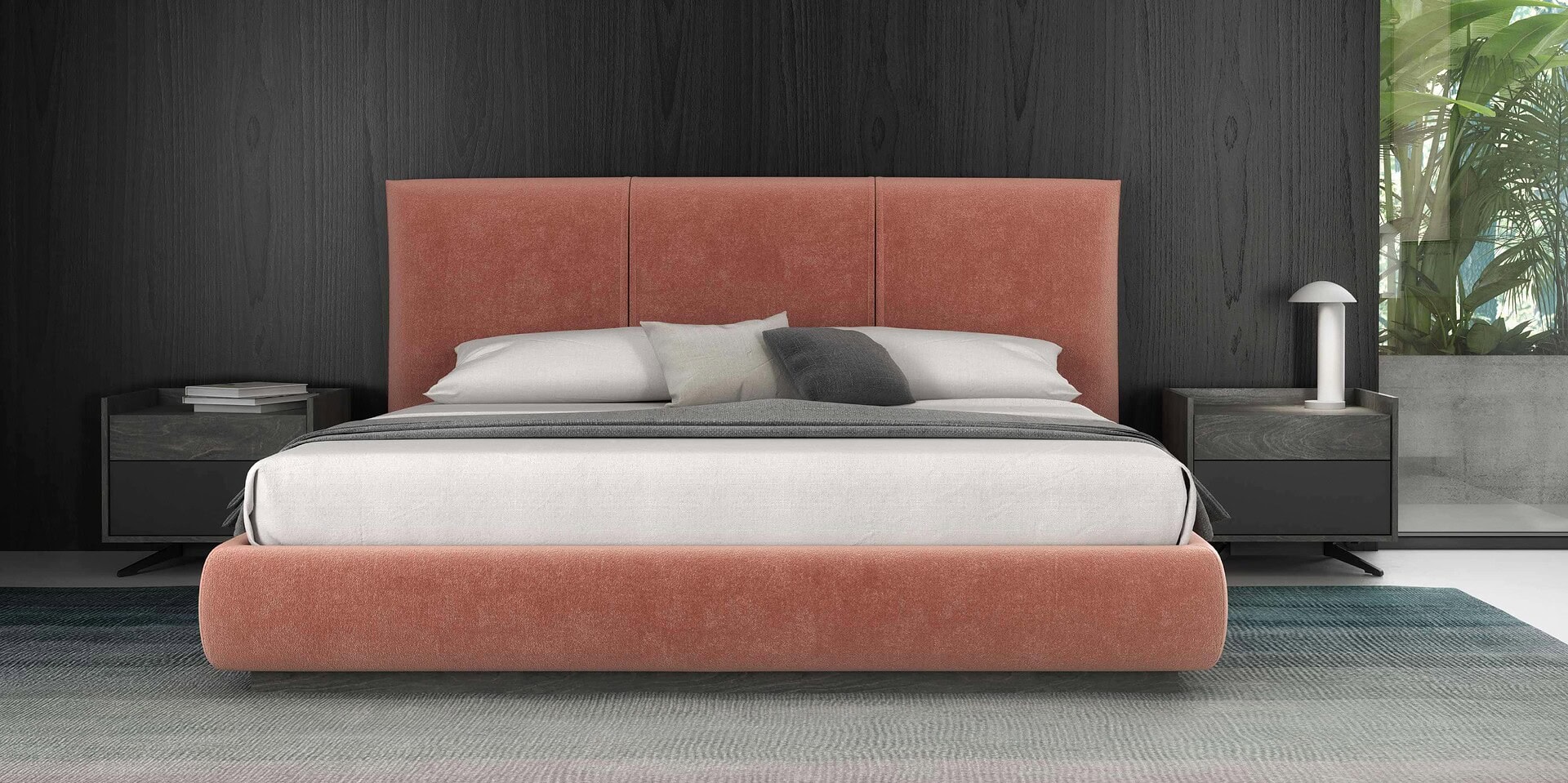 Luxurious modern bedroom with coral upholstered bed, black nightstands, and contemporary decor.