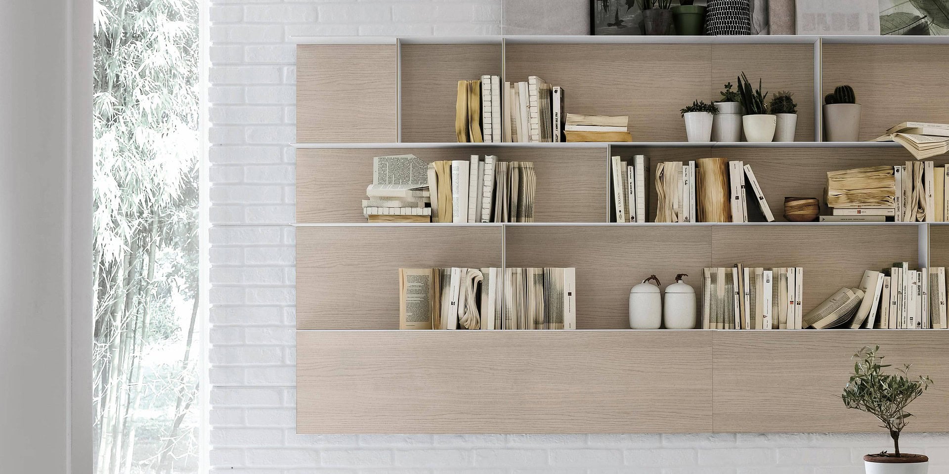 Sleek modern bookshelf with light wood finish in stylish home decor setting.
