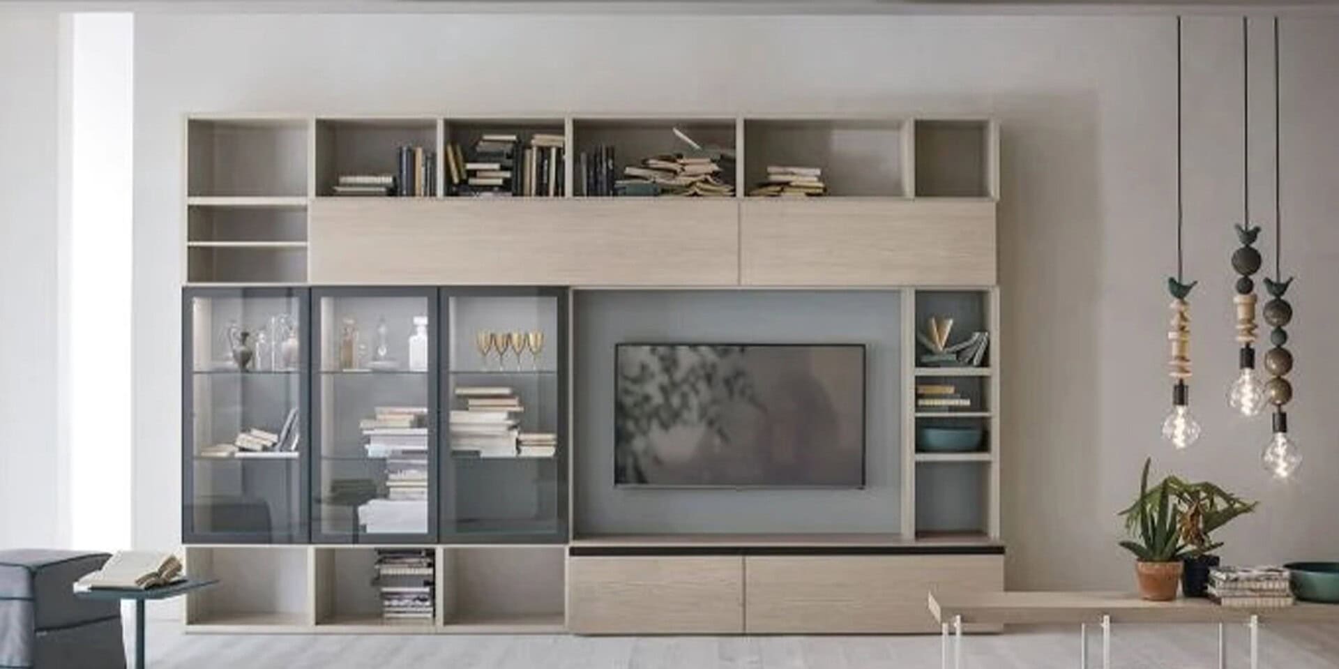 Stylish modern white and gray entertainment center with bookshelves and glass cabinets for living room decor.