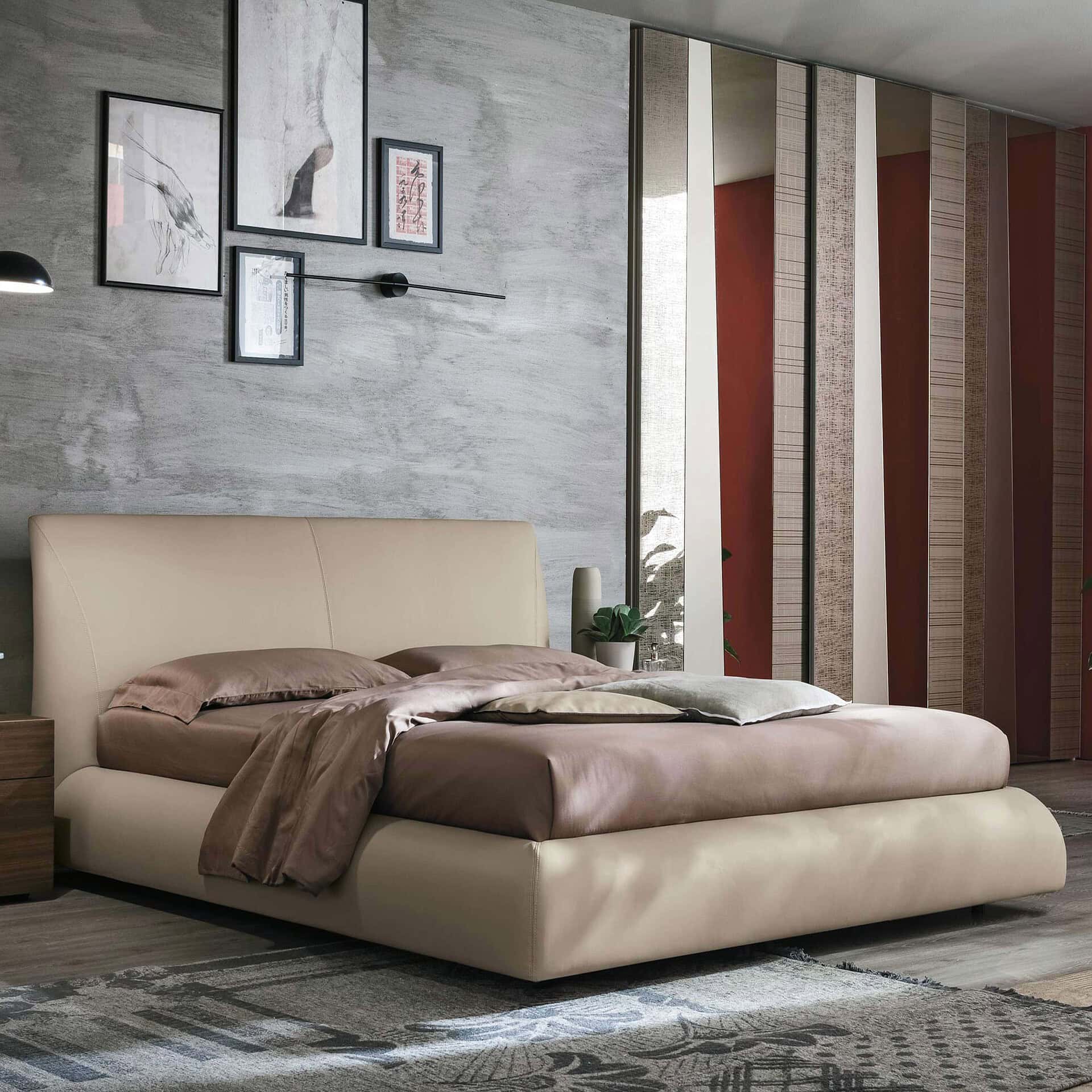 Luxurious modern bedroom with a plush beige bed and contemporary decor, showcasing Sklar Furnishings craftsmanship.