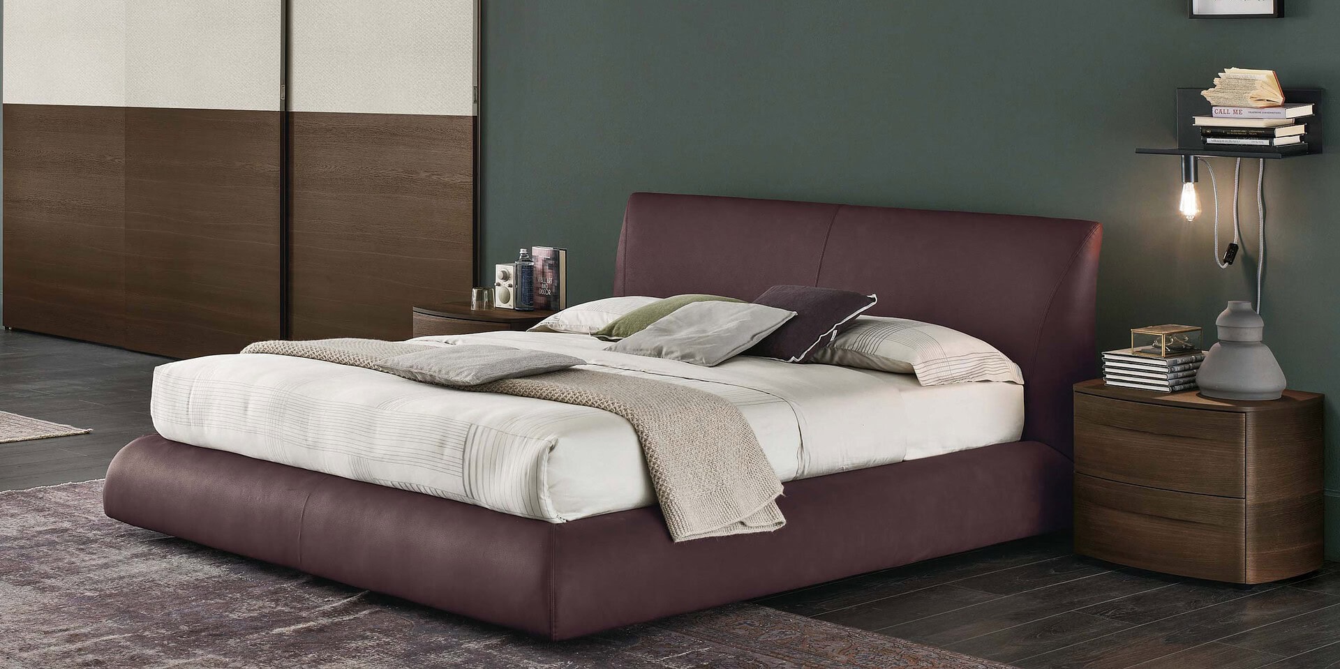 Luxury upholstered bedroom with modern wood side tables and contemporary decor accents.