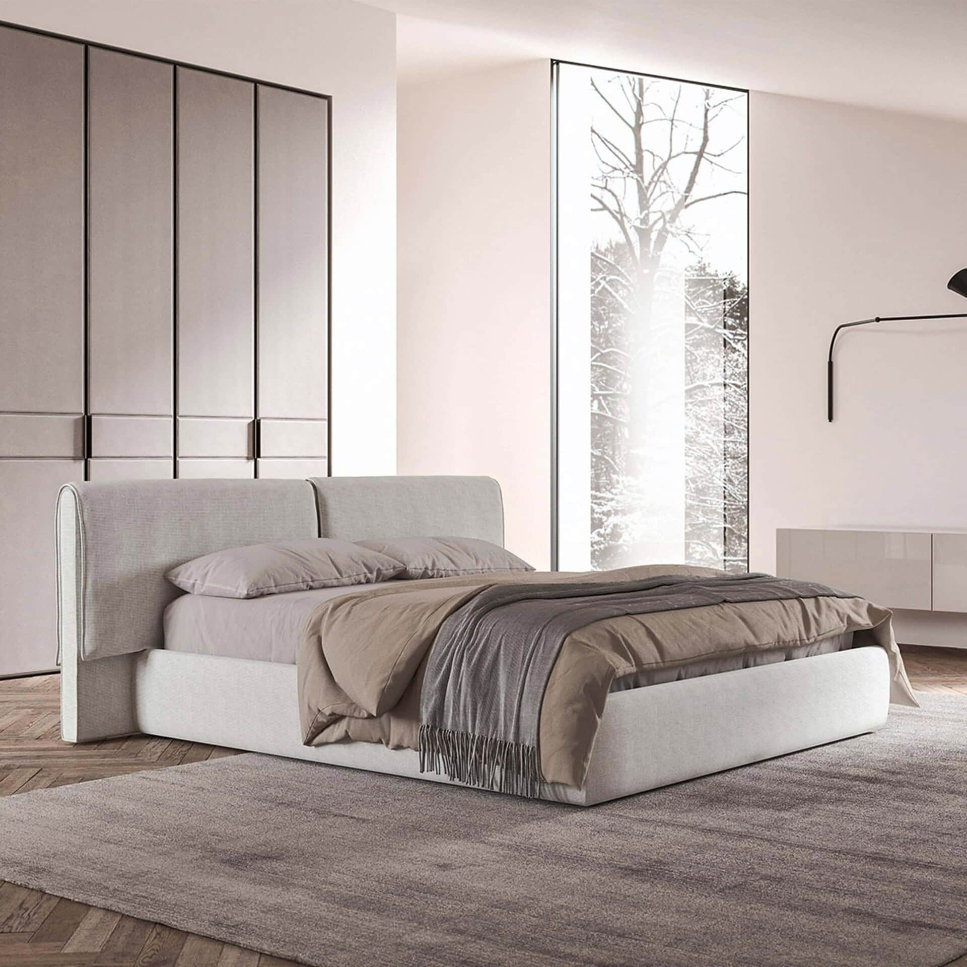 Contemporary upholstered bed with neutral-toned bedding in a modern bedroom setting.