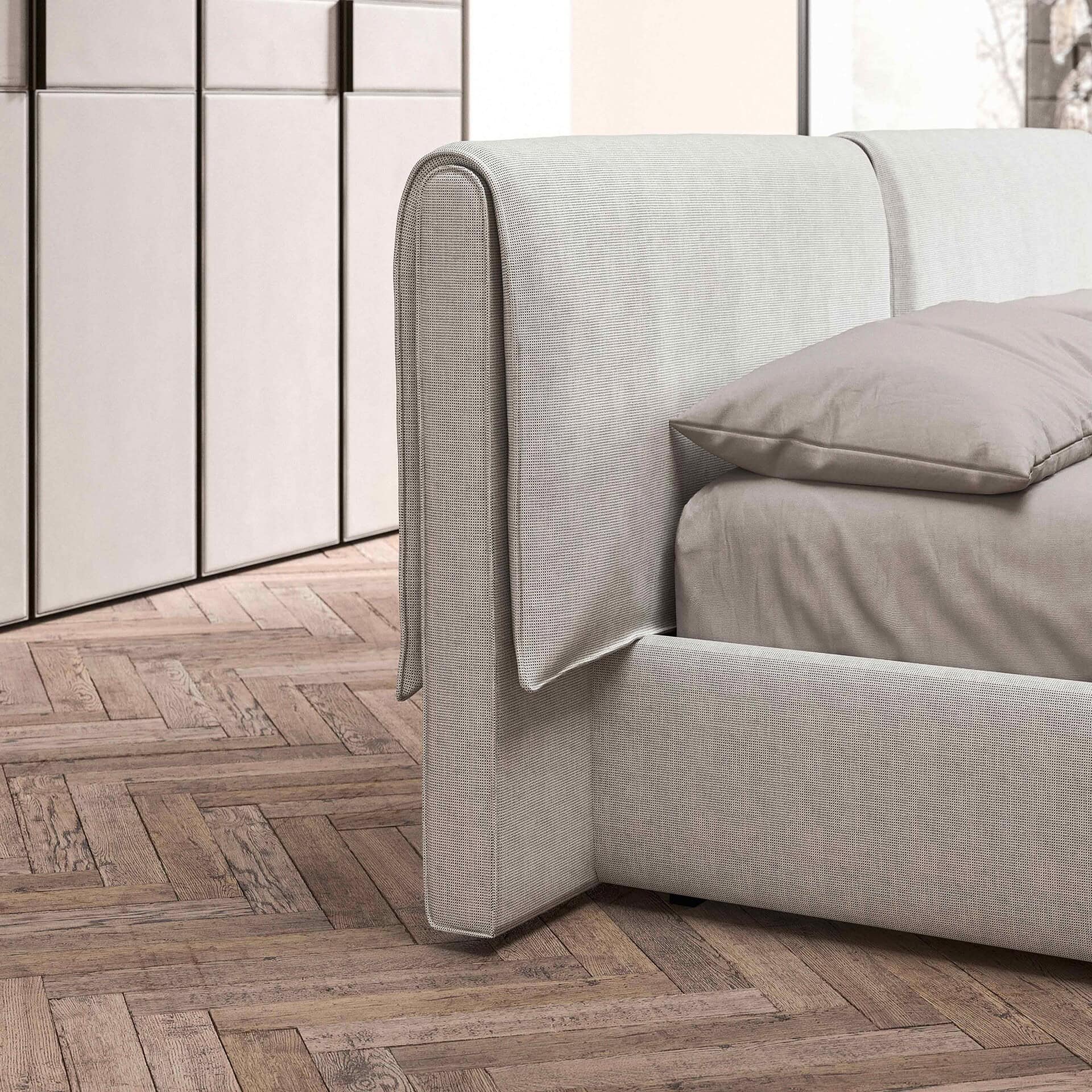 Luxurious upholstered bed with neutral fabric, elegant headboard design for modern bedrooms.