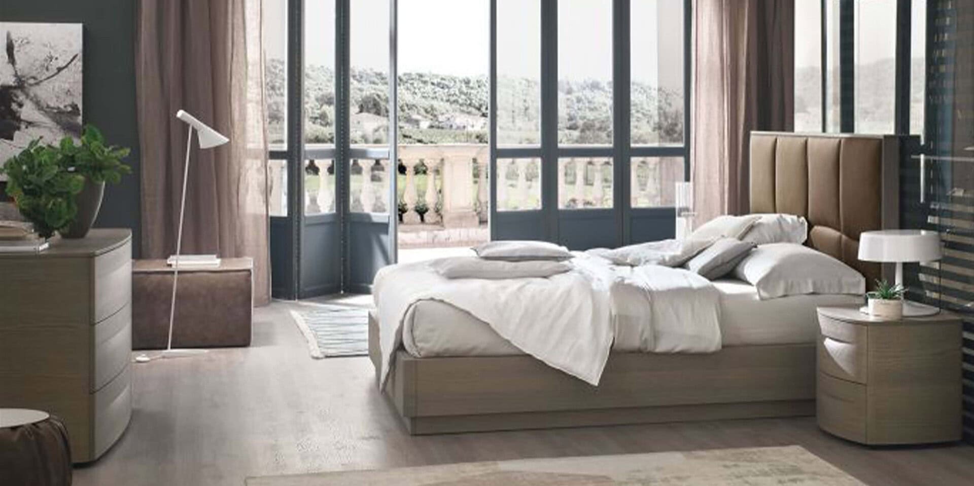 Luxurious modern bedroom featuring custom Sklar Furnishings furniture with a view of a balcony and natural light.