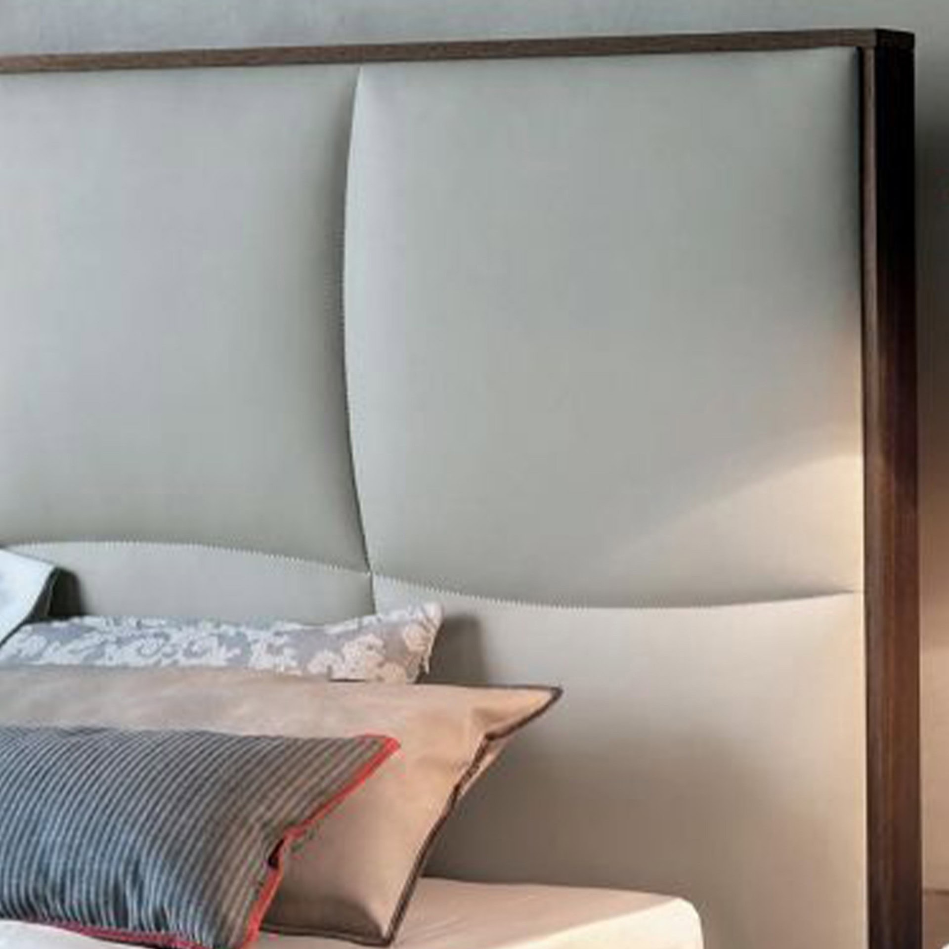 Luxurious upholstered bed headboard with modern design and wooden frame accents.