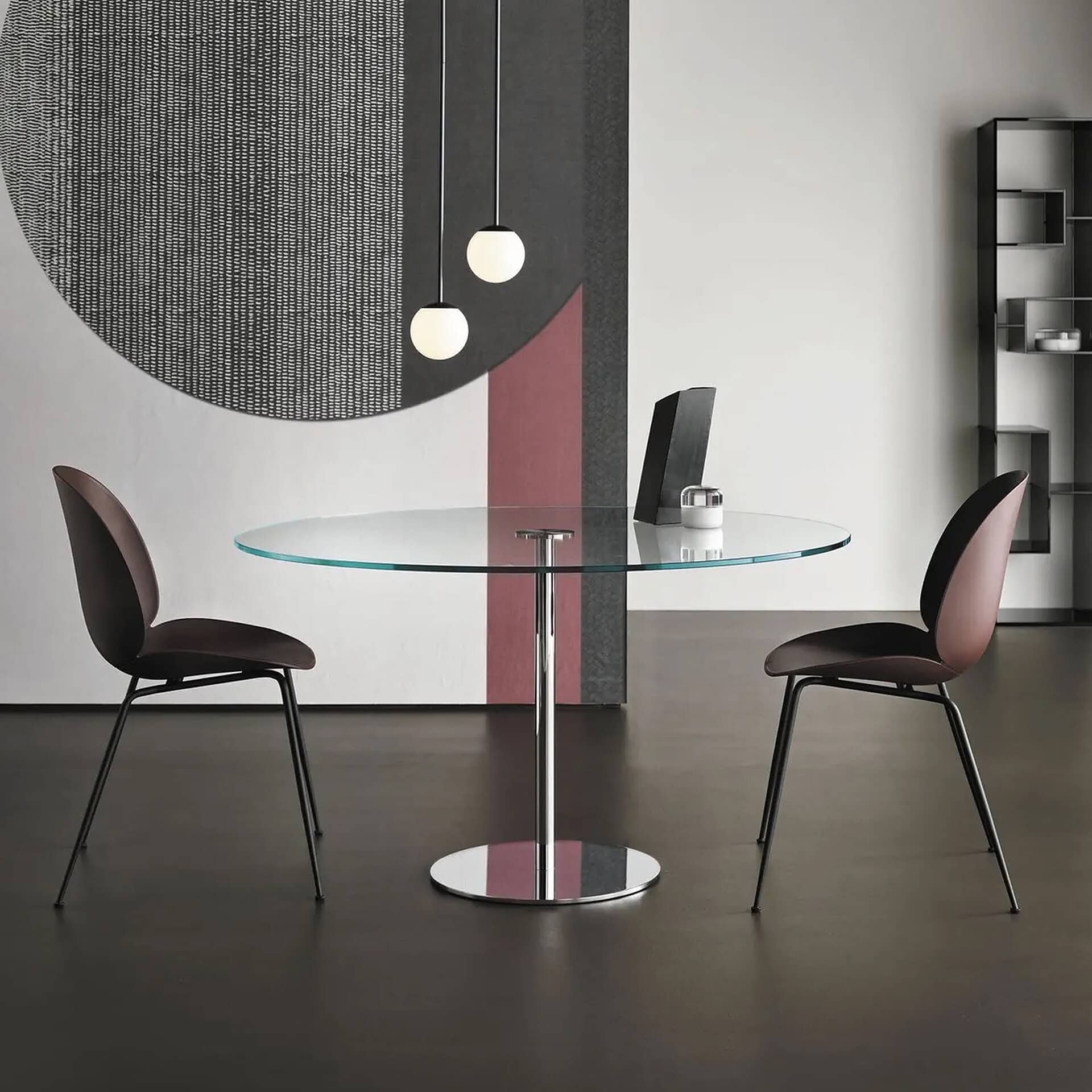 Modern glass dining table with two stylish chairs in a contemporary interior setting.