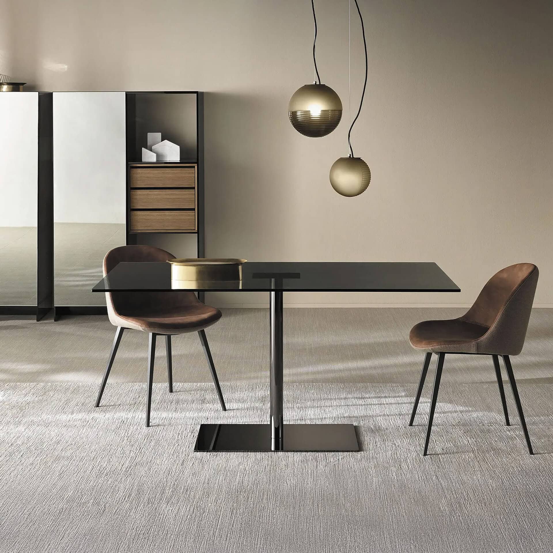 Modern dining room with black glass table and stylish chairs.