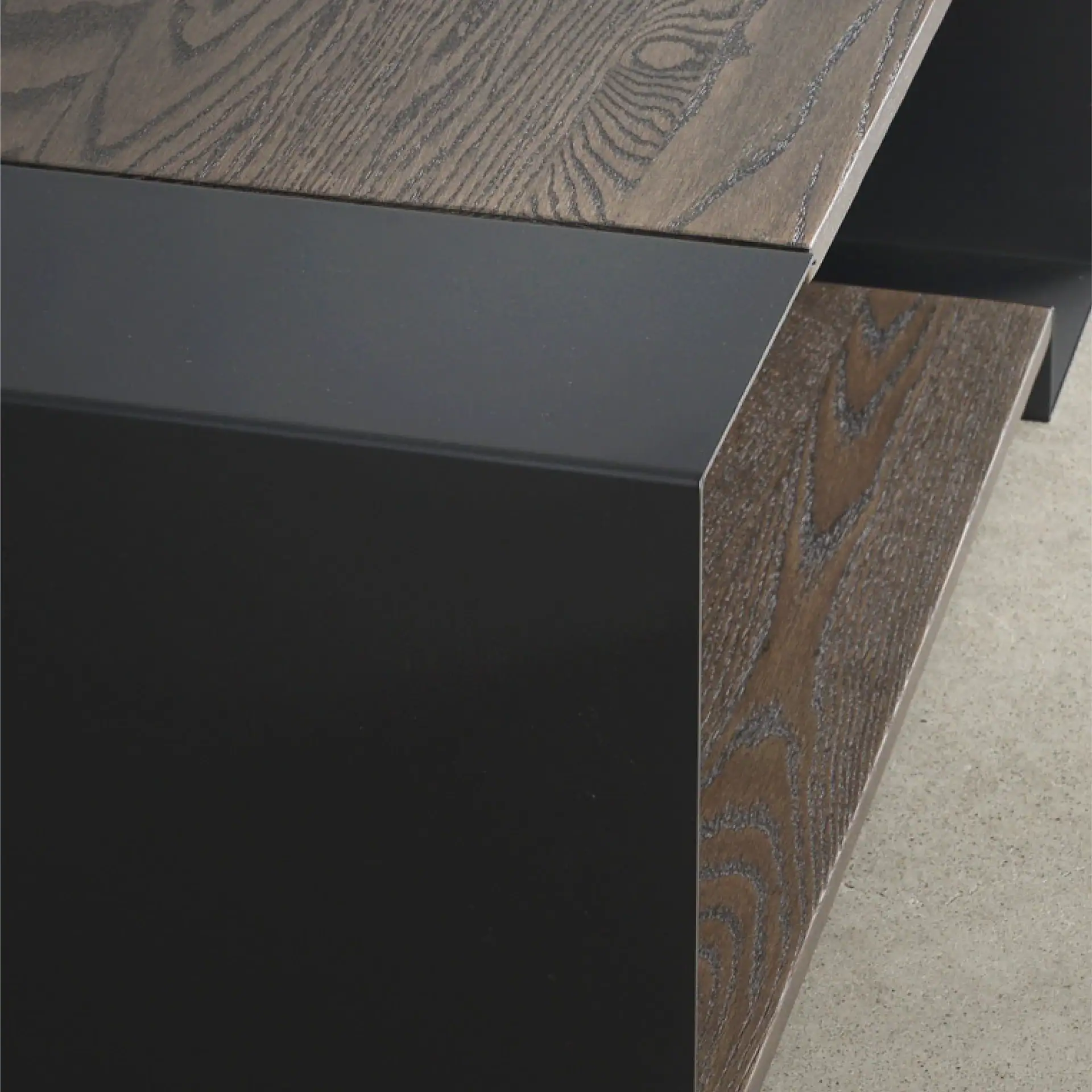 Close-up of Duo Table showing wood and black metal finish.