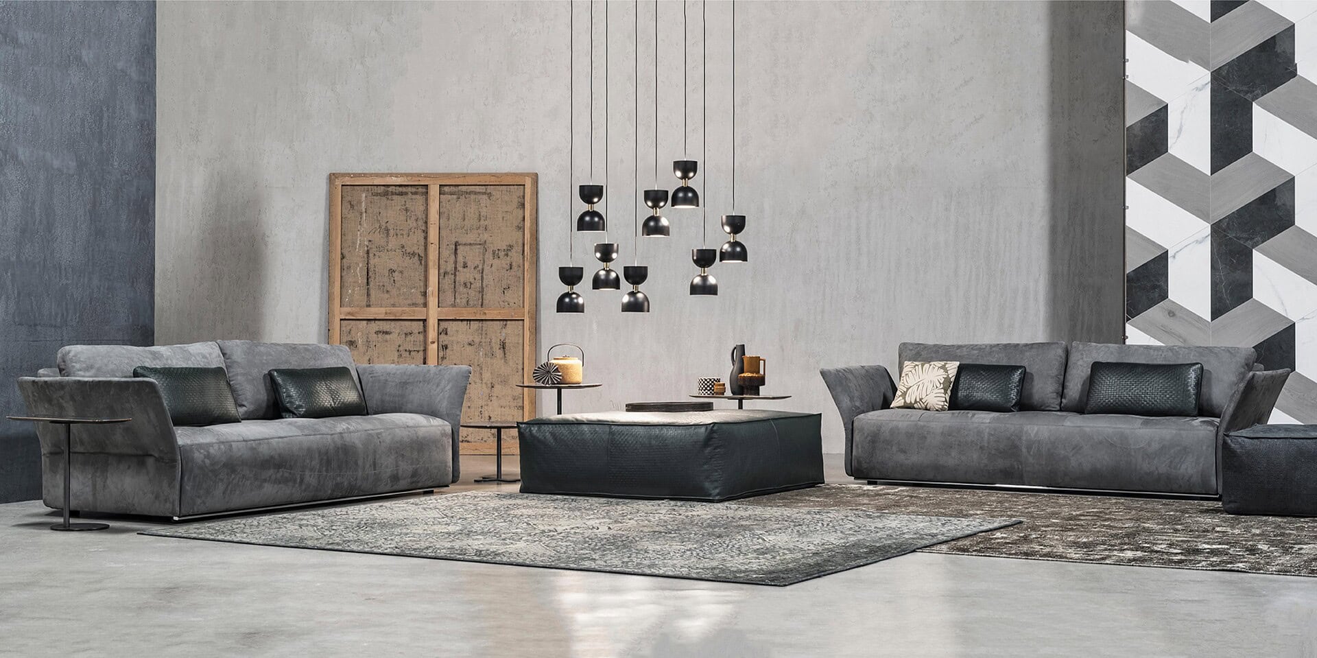 Contemporary gray upholstered sofas in a modern living room with minimalist decor.