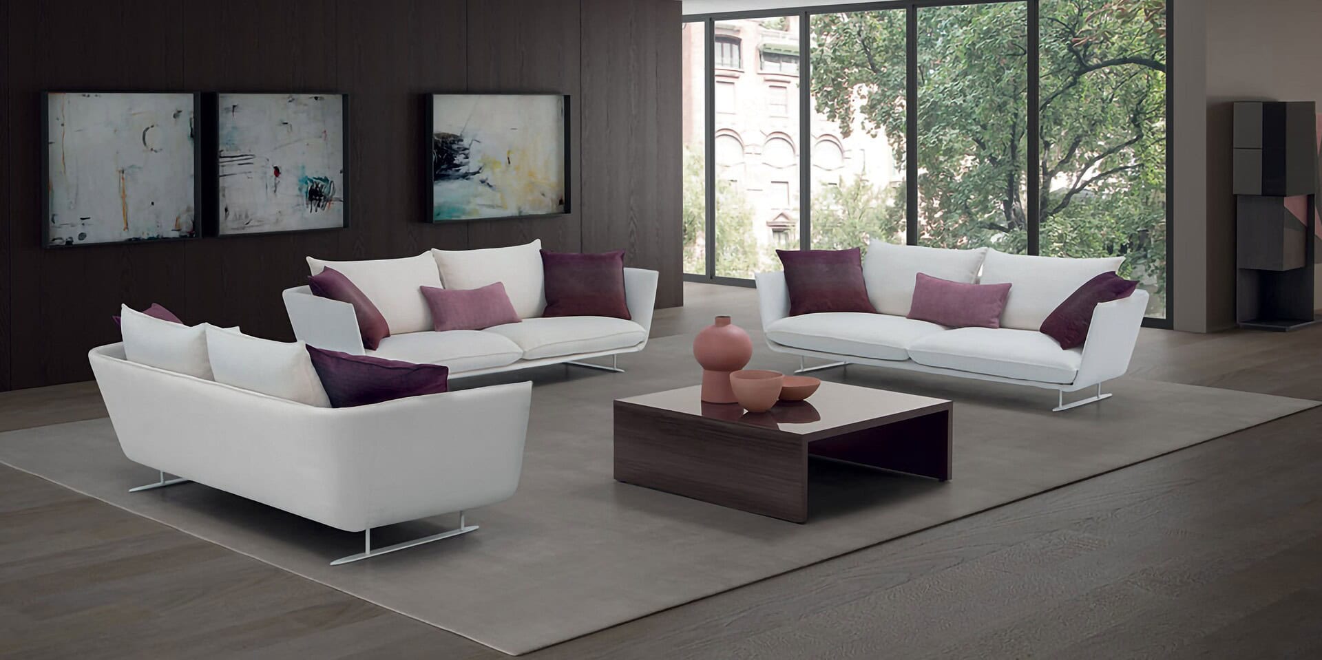 Elegant modern living room with white sofas, purple cushions, and large windows, showcasing Sklar Furnishings' stylish furniture.