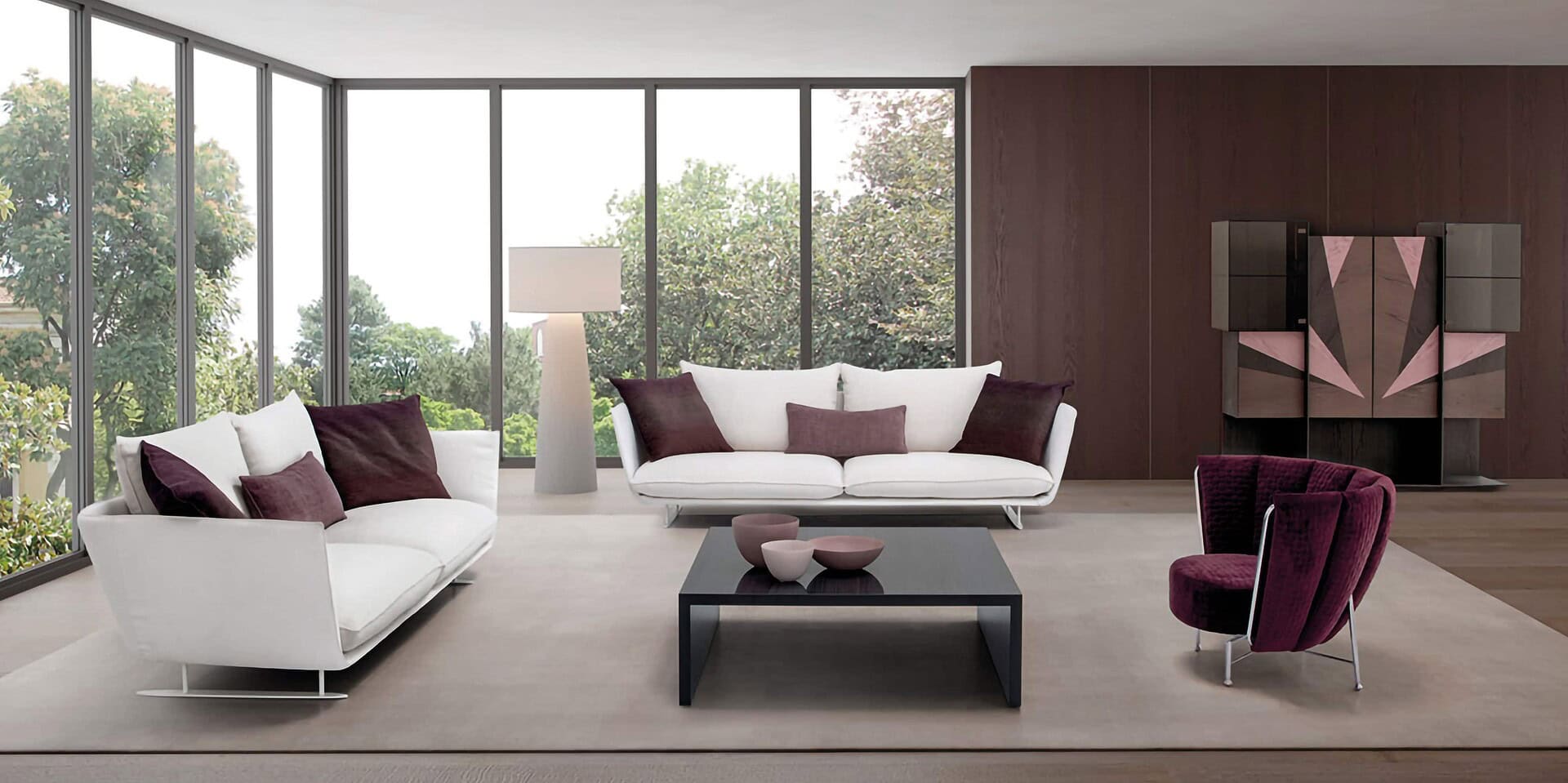 Elegant modern living room with white and burgundy sofas, statement armchair, and contemporary decor.