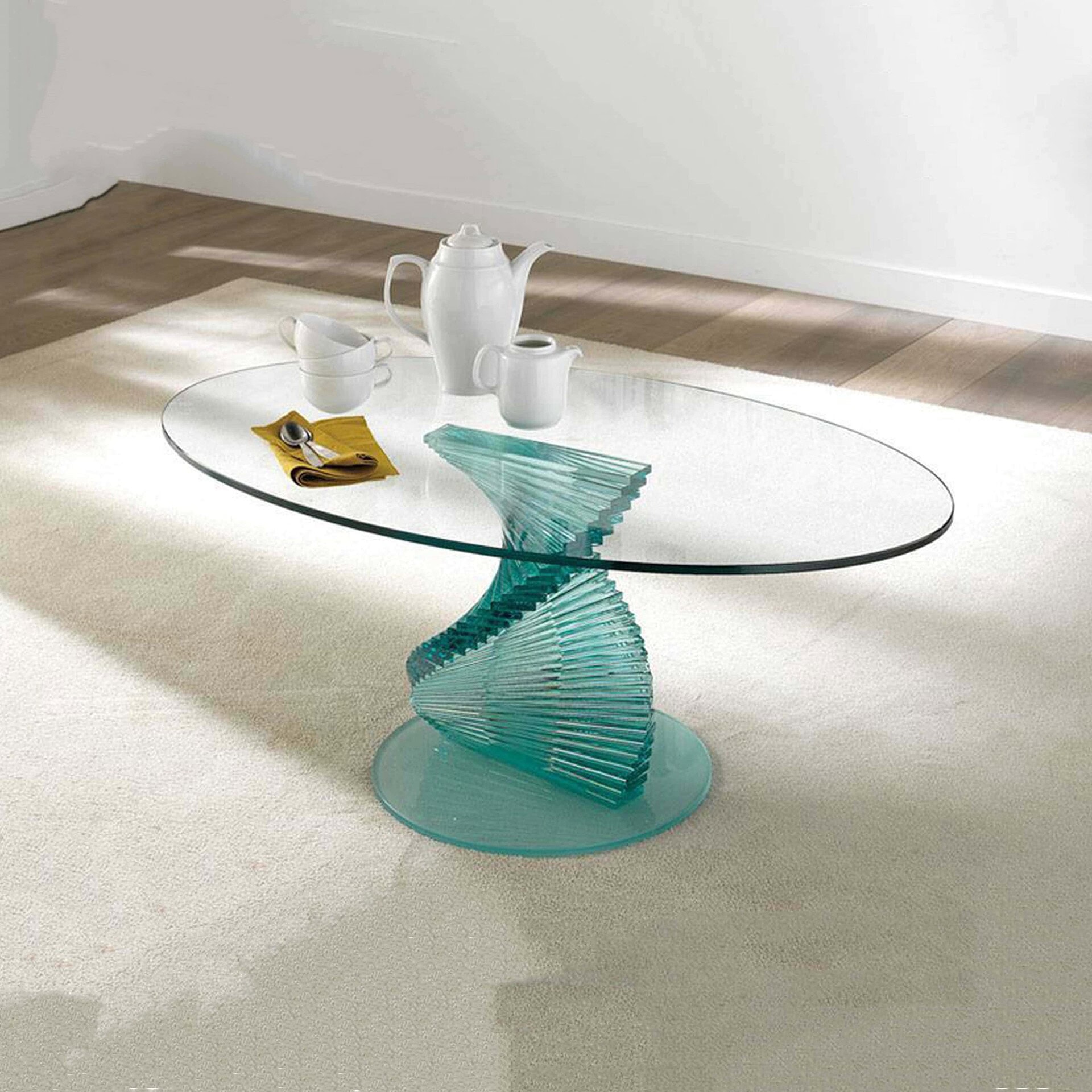 Sleek glass coffee table with a twisted turquoise base, modern design for contemporary living spaces.