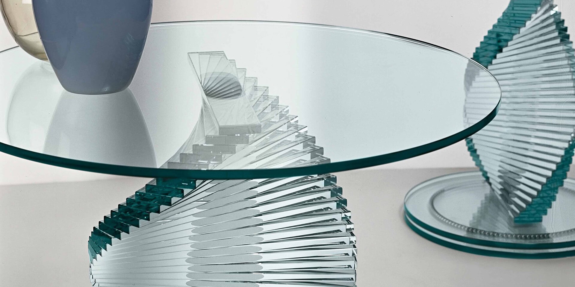 Elegant glass coffee table with modern sculptural base for stylish living spaces.