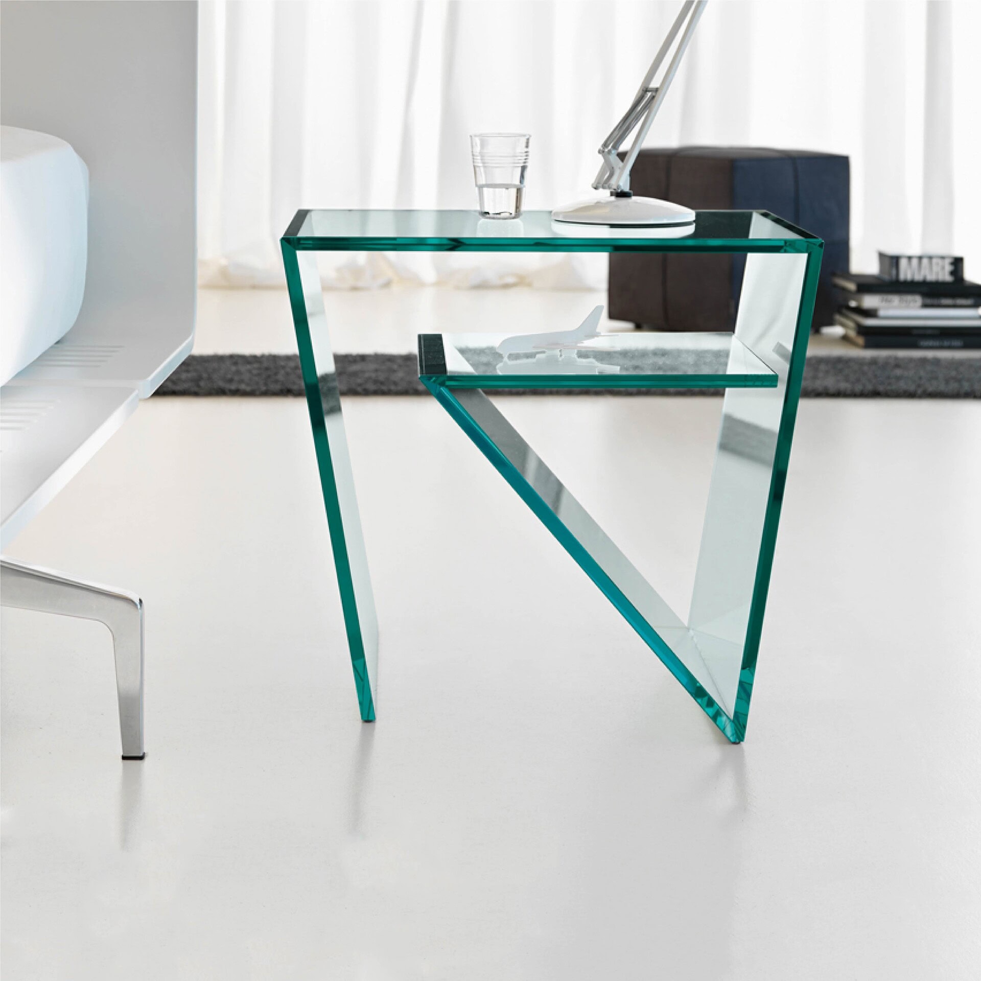 Polished glass side table with geometric modern design, ideal for contemporary living spaces.