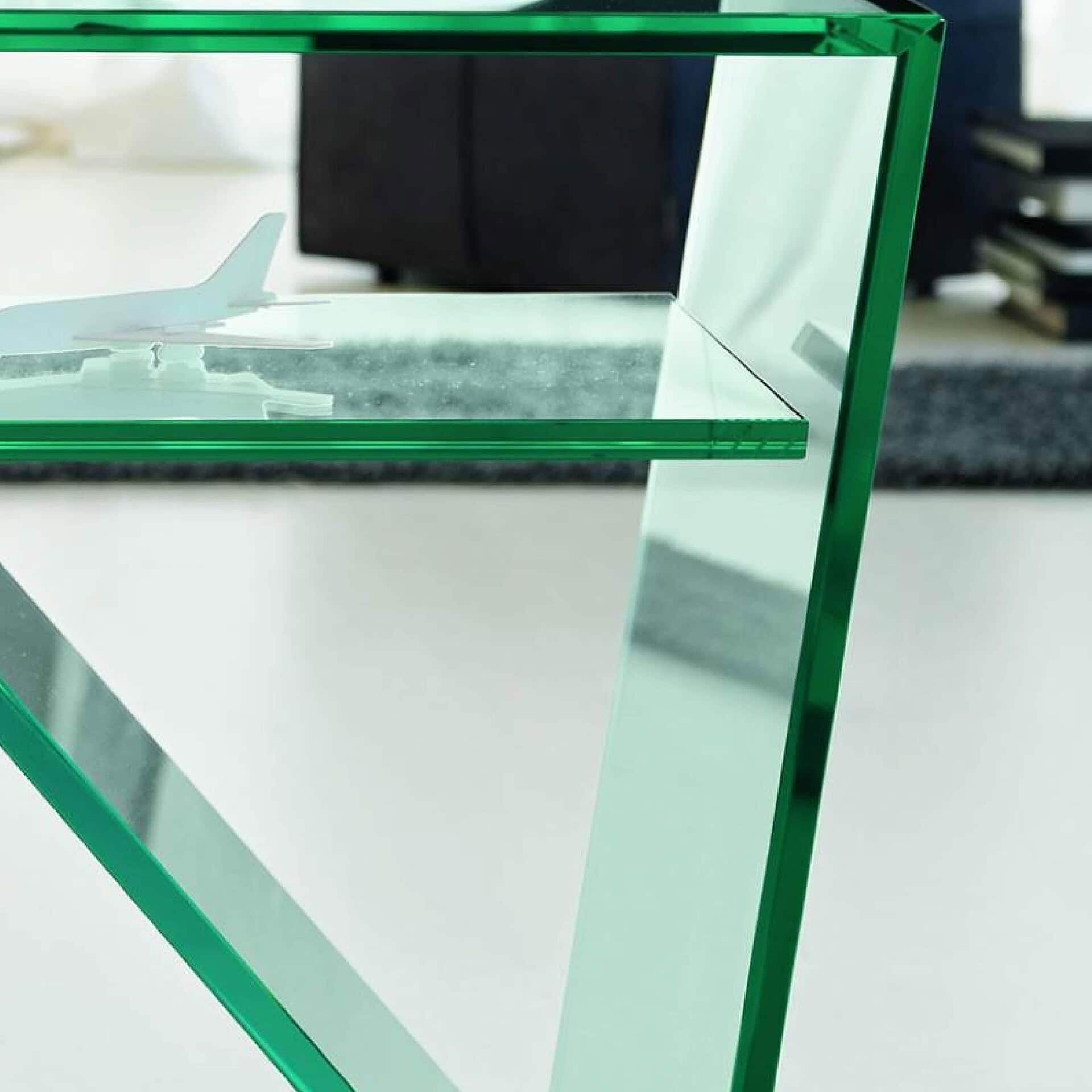 Sleek glass desk with green tinted transparent edges and modern design by Sklar Furnishings.