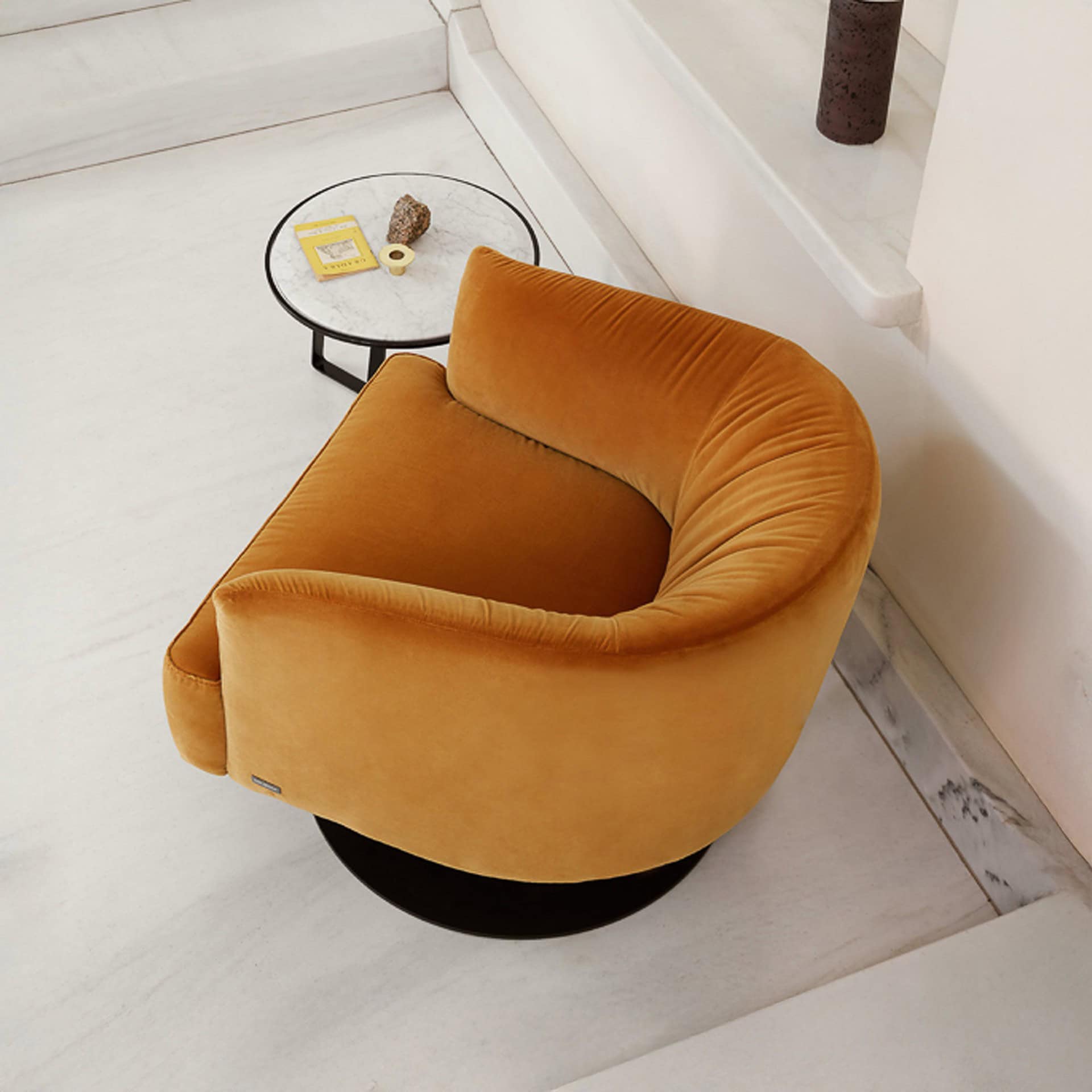 Close-up angled view of the Nicoline Diga Swivel Chair showing its curved back and plush cushioning.