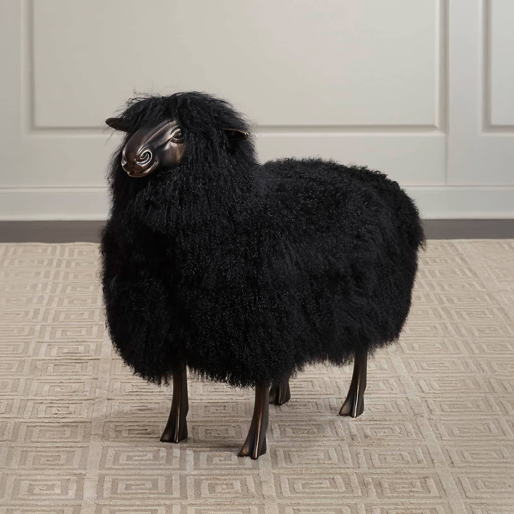 Leon Sheep Sculpture in black sheepskin with bronze base, styled in interior setting