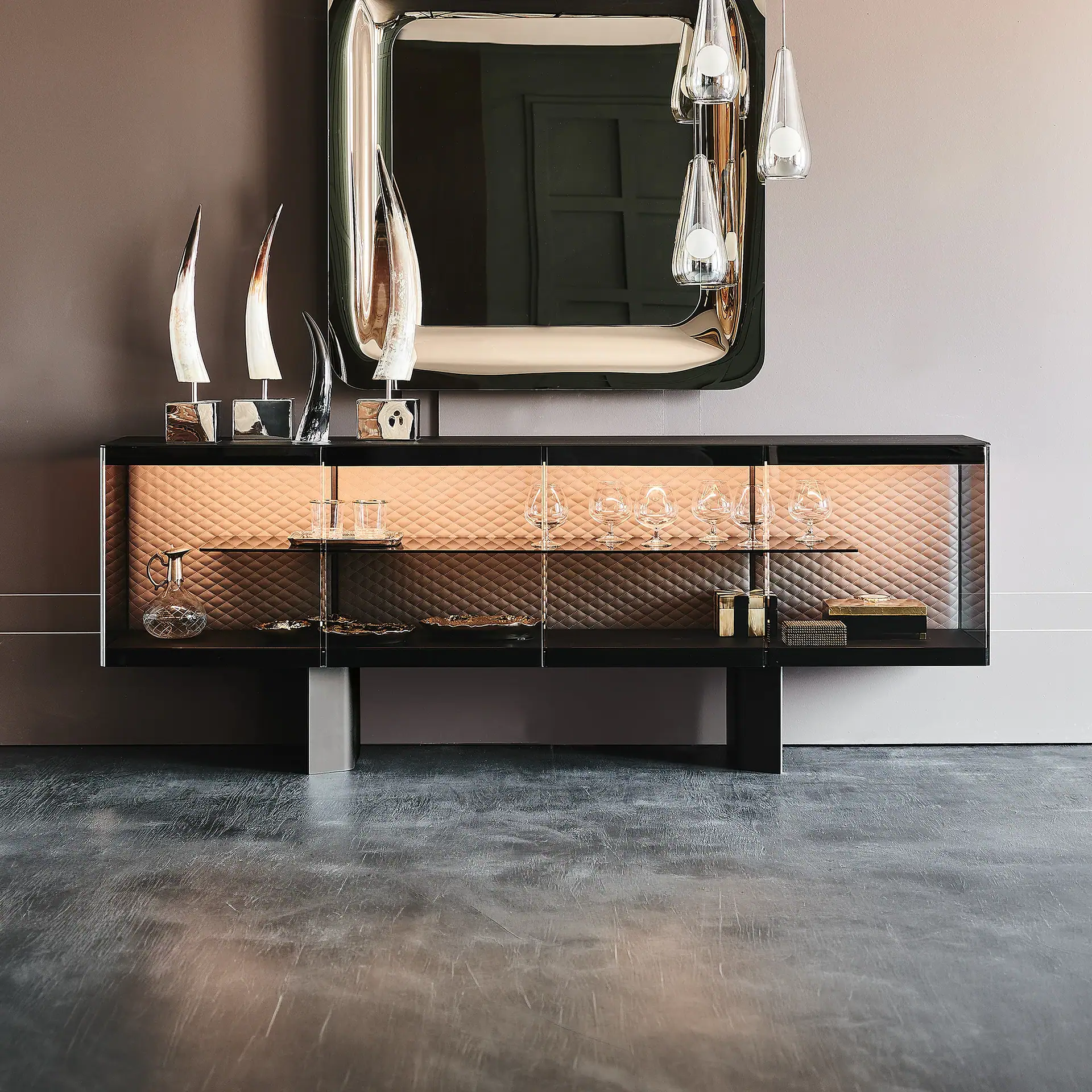 Elegant black and copper boutique sideboard with glass doors and decorative items.