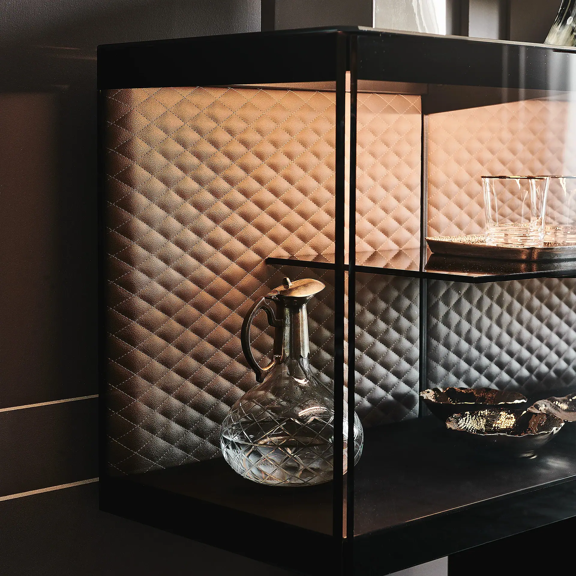 Elegant black display cabinet with glass shelves and decorative items inside.