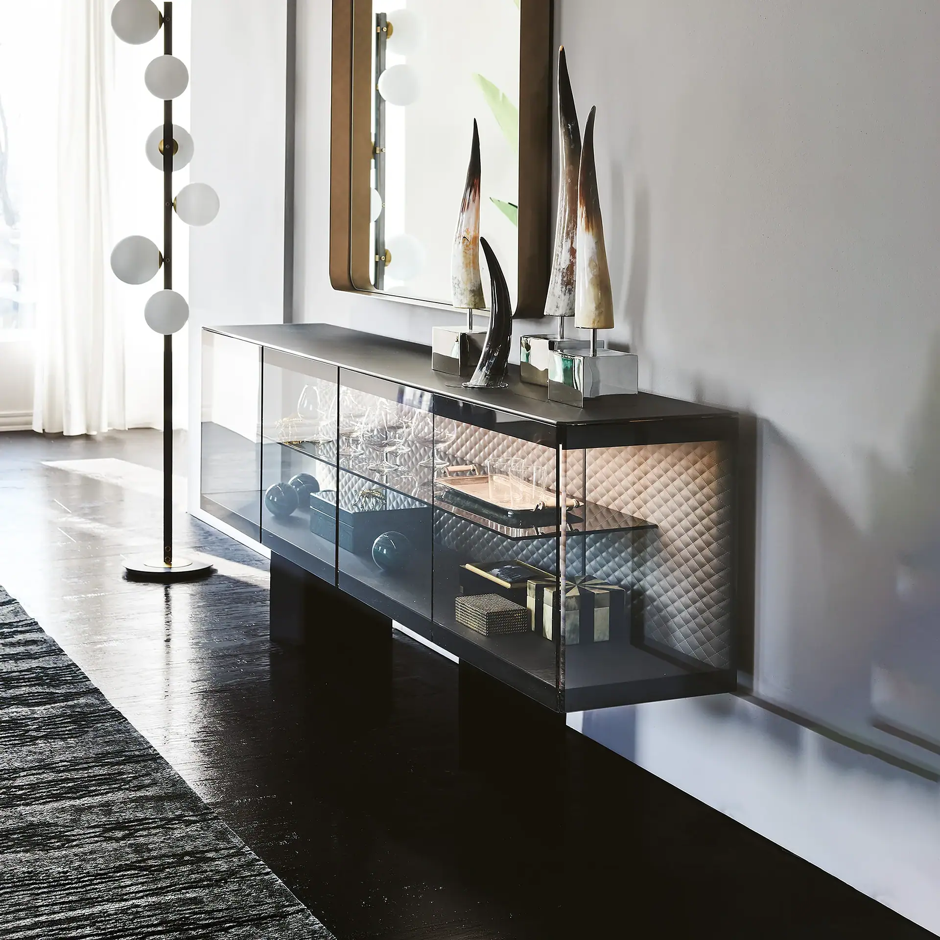 Modern boutique sideboard with glass doors and decorative sculptures.