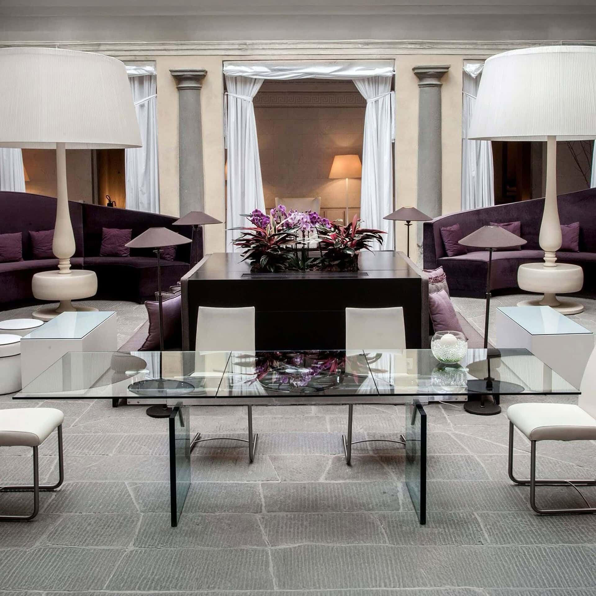 Dining room setting featuring the Quasar Extendable Dining Table with glass top